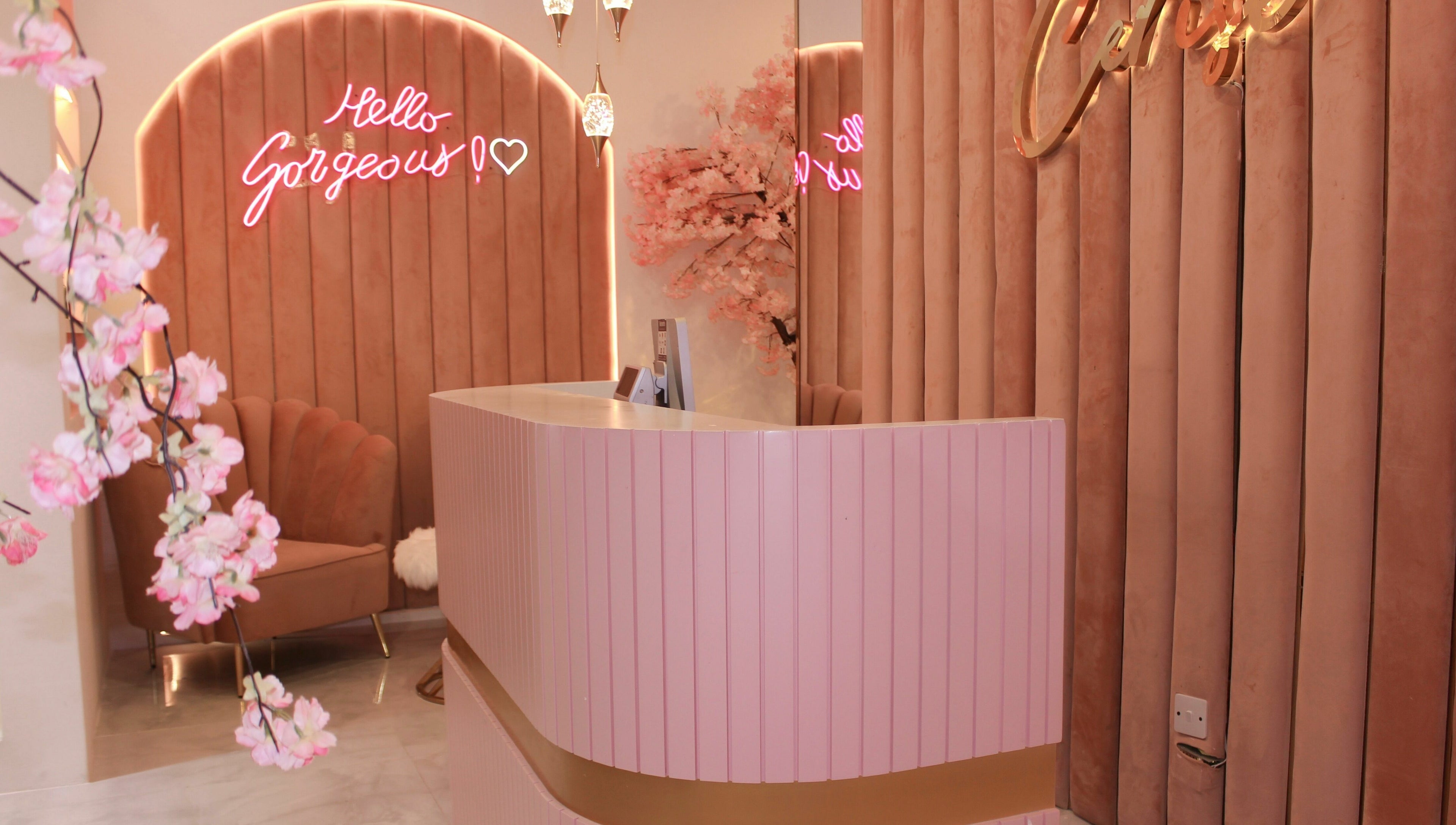 Welcoming reception at Cerise Beauty Salon in Dubai, Dubai, AE with pink decor and chic seating.