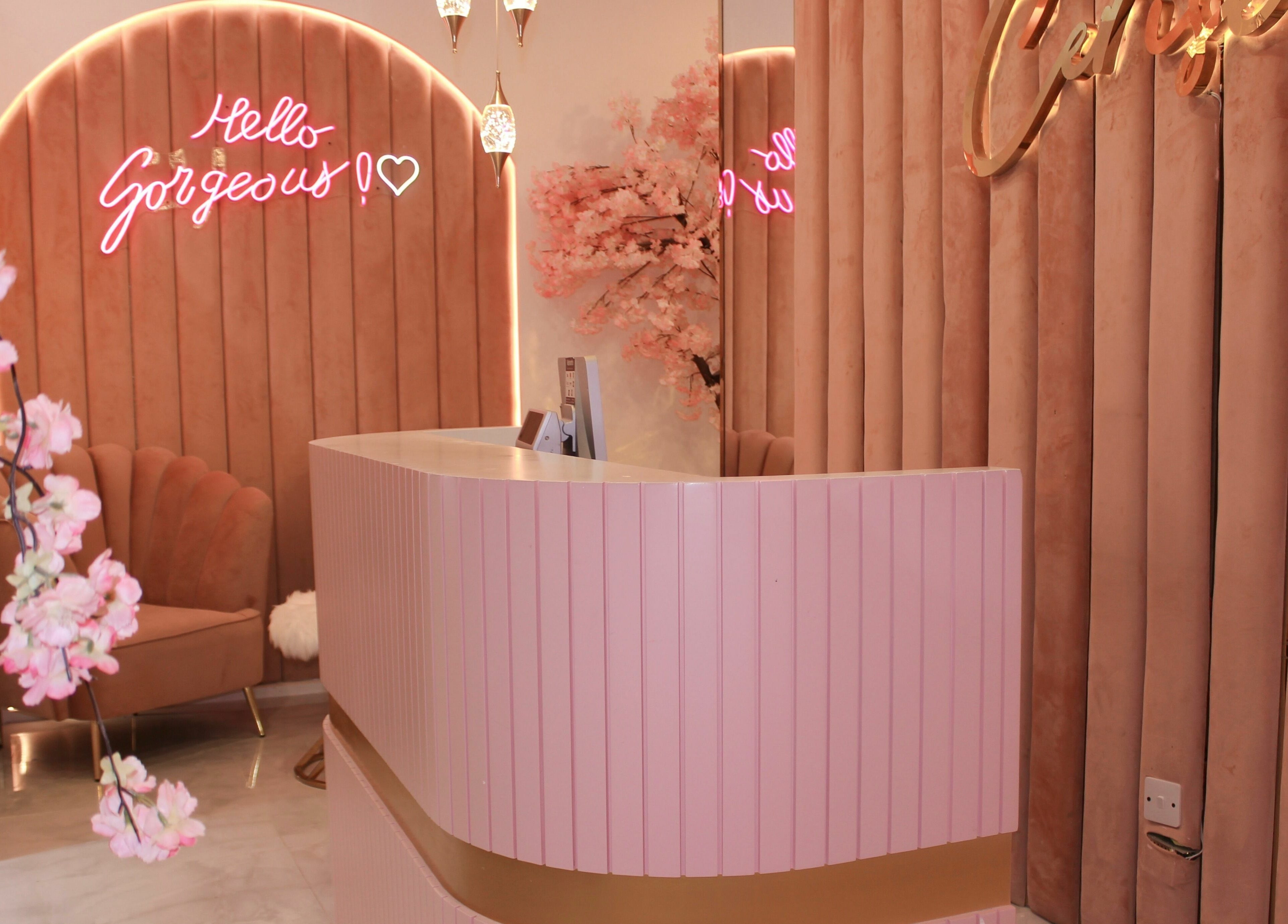 Welcoming reception at Cerise Beauty Salon in Dubai, Dubai, AE with pink decor and chic seating.