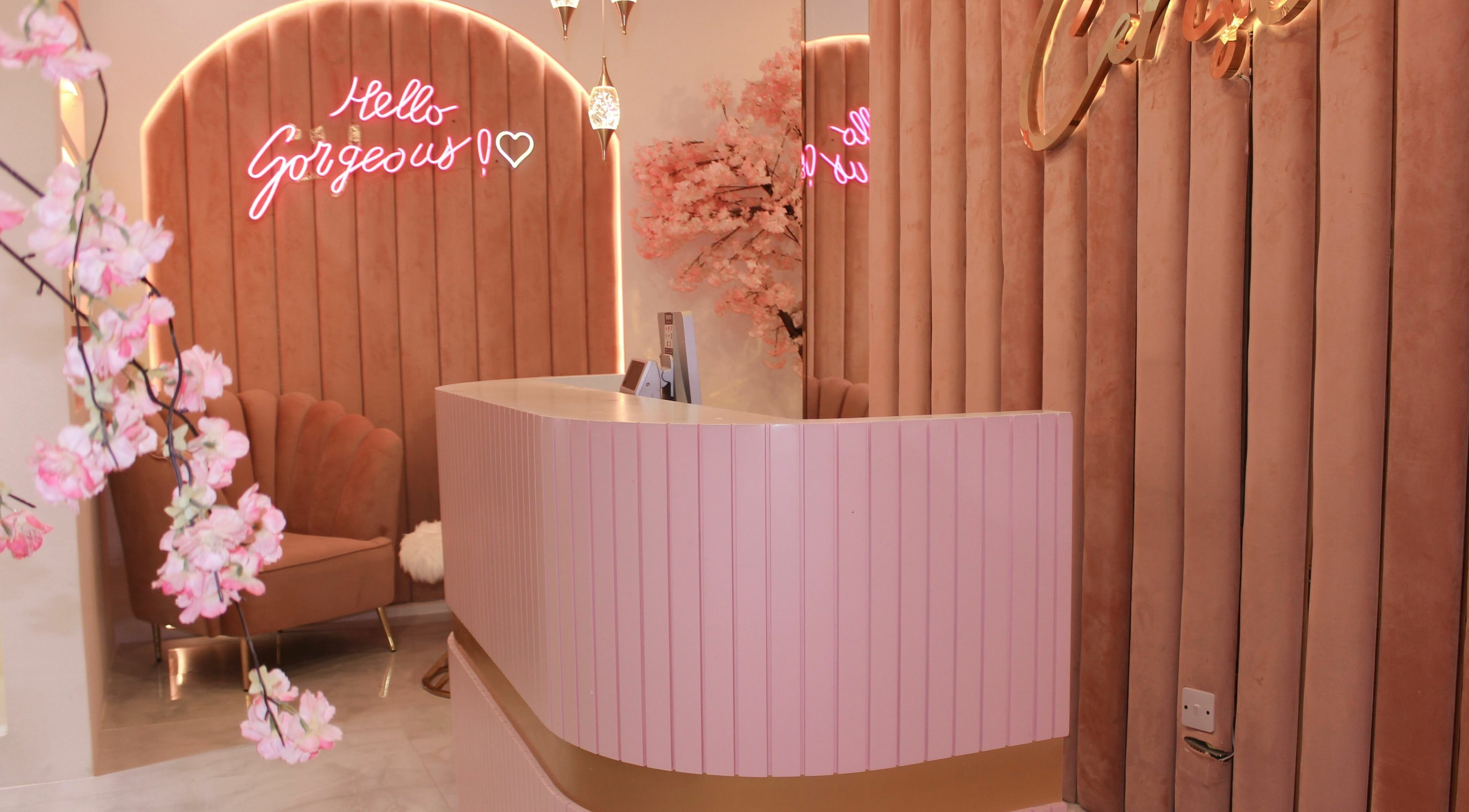 Welcoming reception at Cerise Beauty Salon in Dubai, Dubai, AE with pink decor and chic seating.