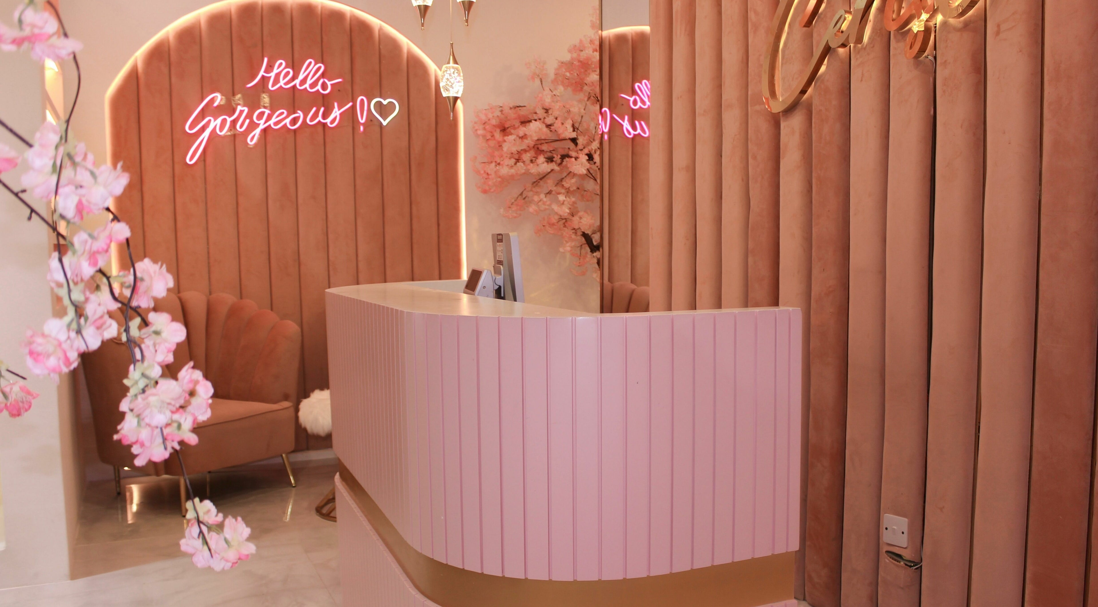 Welcoming reception at Cerise Beauty Salon in Dubai, Dubai, AE with pink decor and chic seating.
