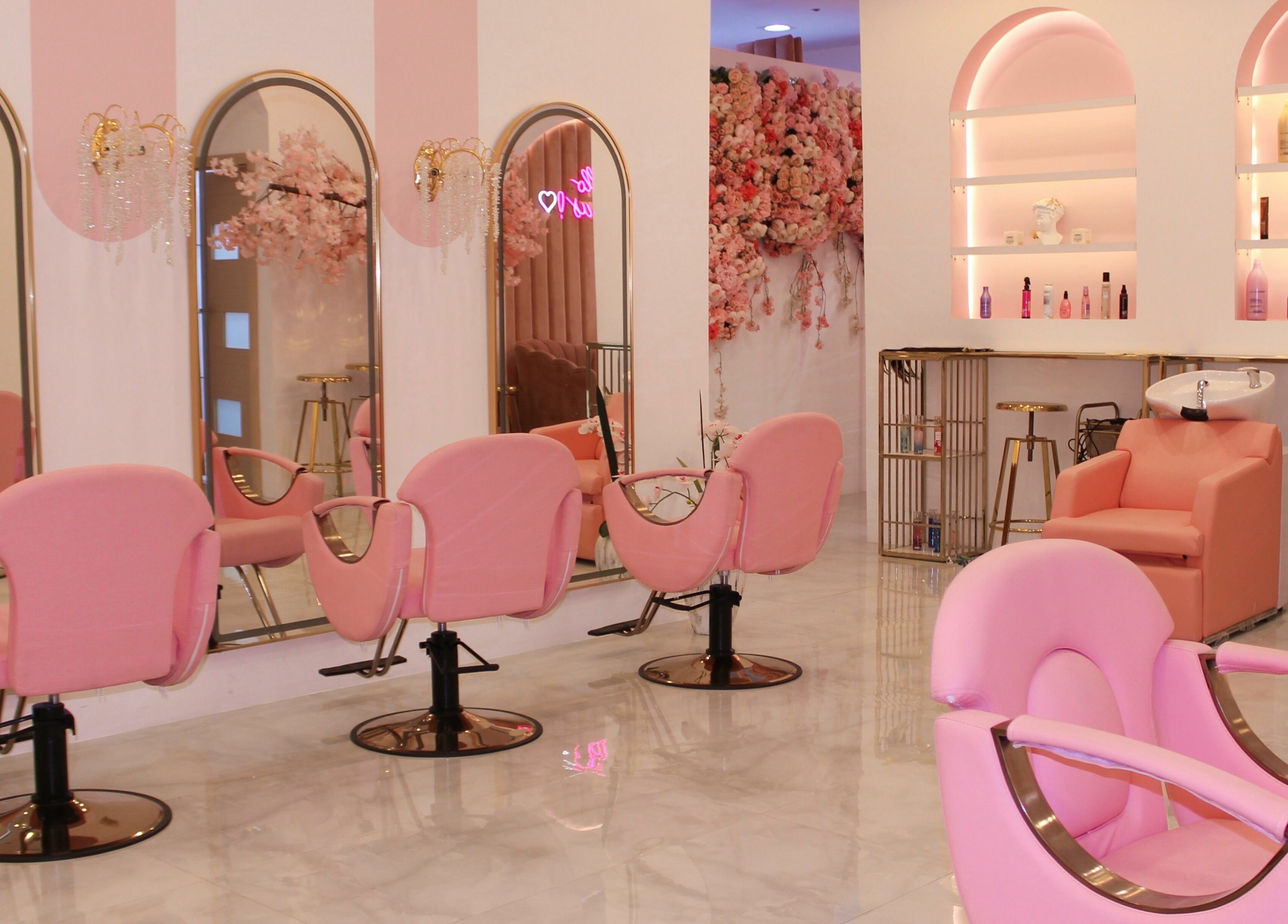 Elegant pink salon interior at Cerise Beauty Salon, Dubai, Dubai, AE, featuring stylish chairs and floral decor.