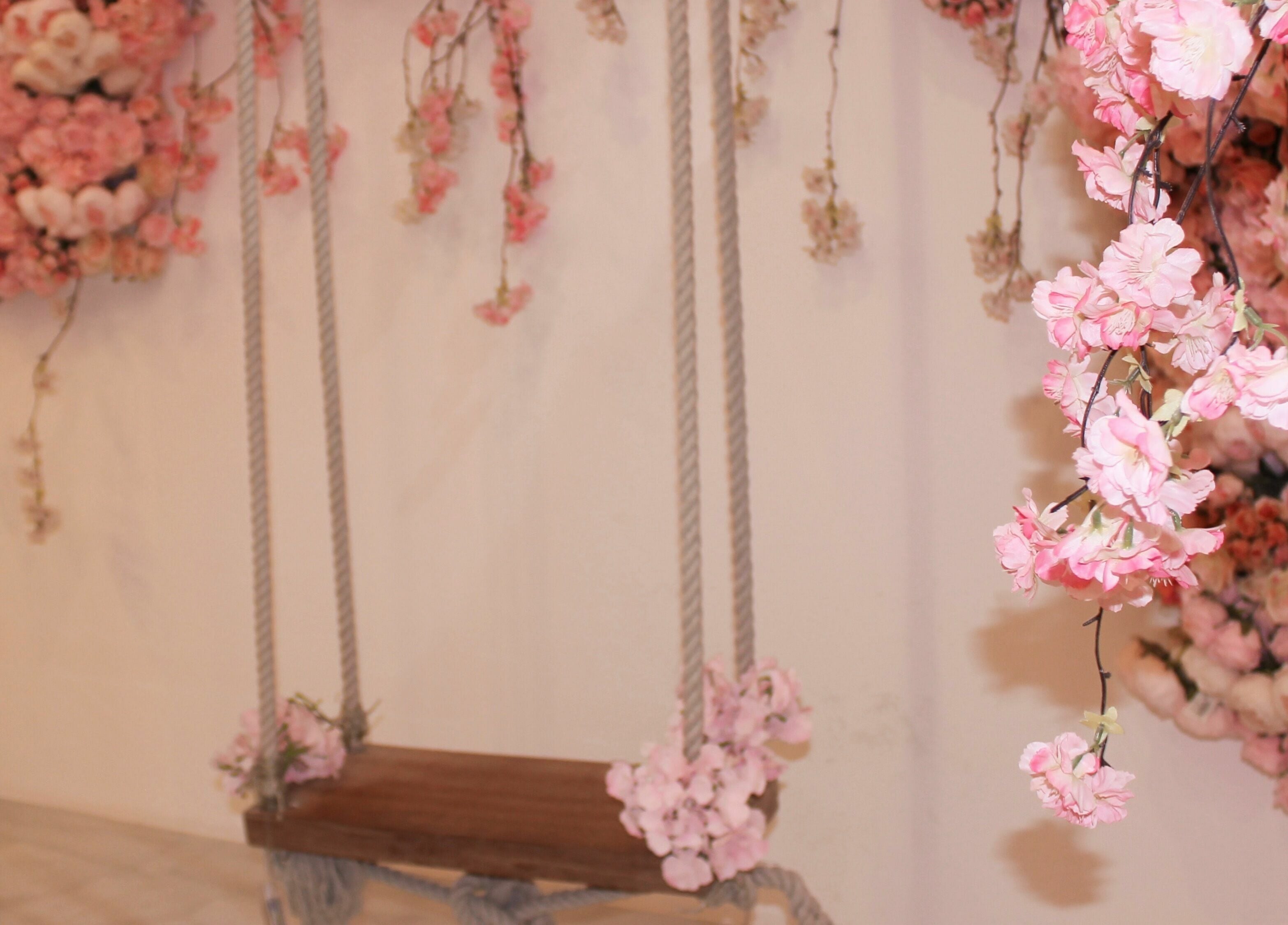 Beautiful floral swing decor at Cerise Beauty Salon in Dubai, Dubai, AE, with lush pink blossoms.