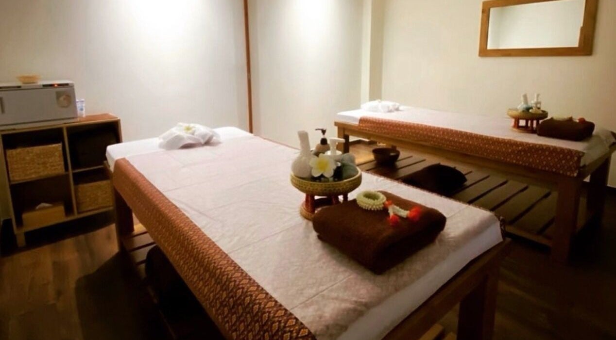 Relaxing massage room at Orchid Thai Spa, Gibraltar, GI. Experience tranquility with traditional décor.