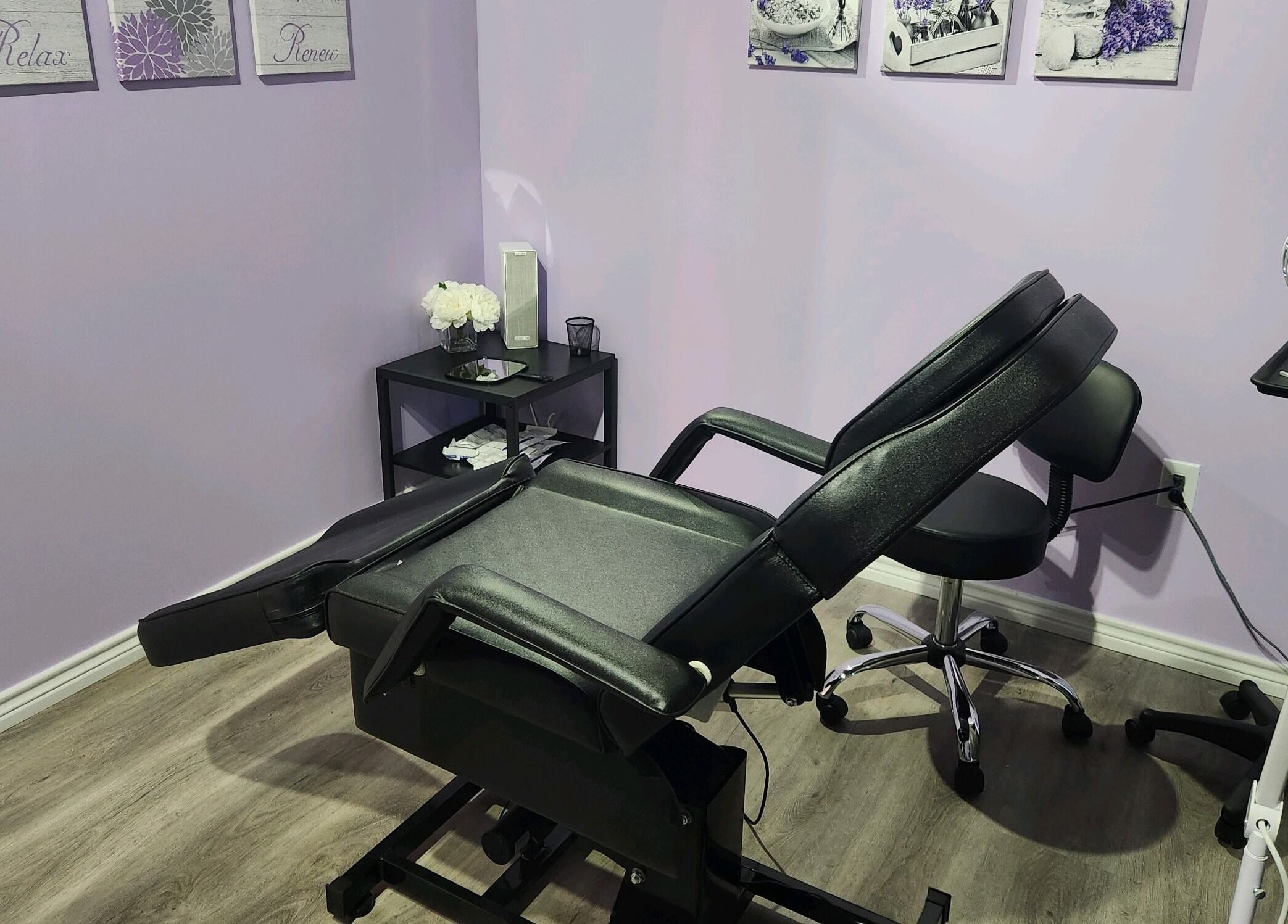 Comfortable treatment room at New You MedSPA Southwest in Houston, Texas, US, with massage chair and decor.