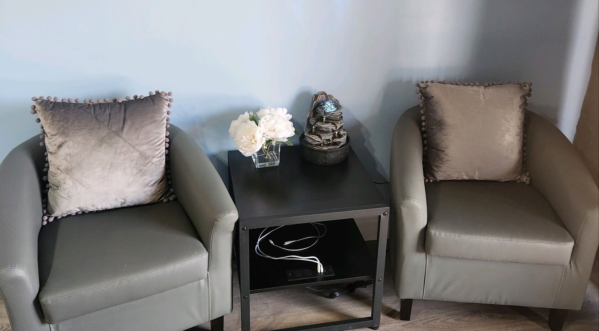 Elegant seating area at New You MedSPA Southwest, Houston, Texas, US with plush chairs and a calming table decor.