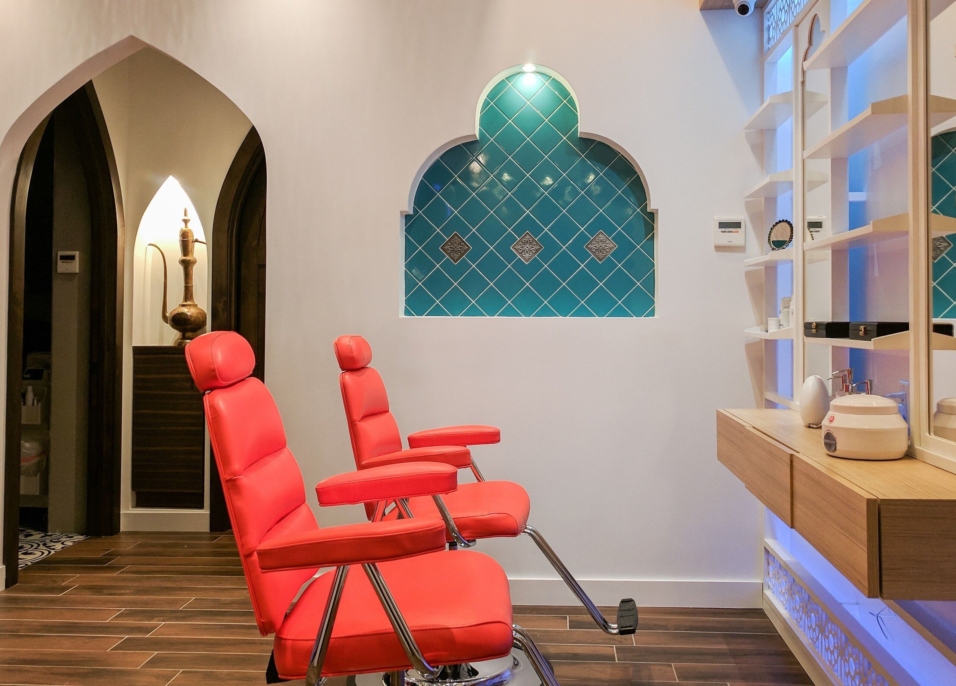 Interior of Blink Brow Bar Bute St, red chairs, elegant design in Vancouver, British Columbia, CA.