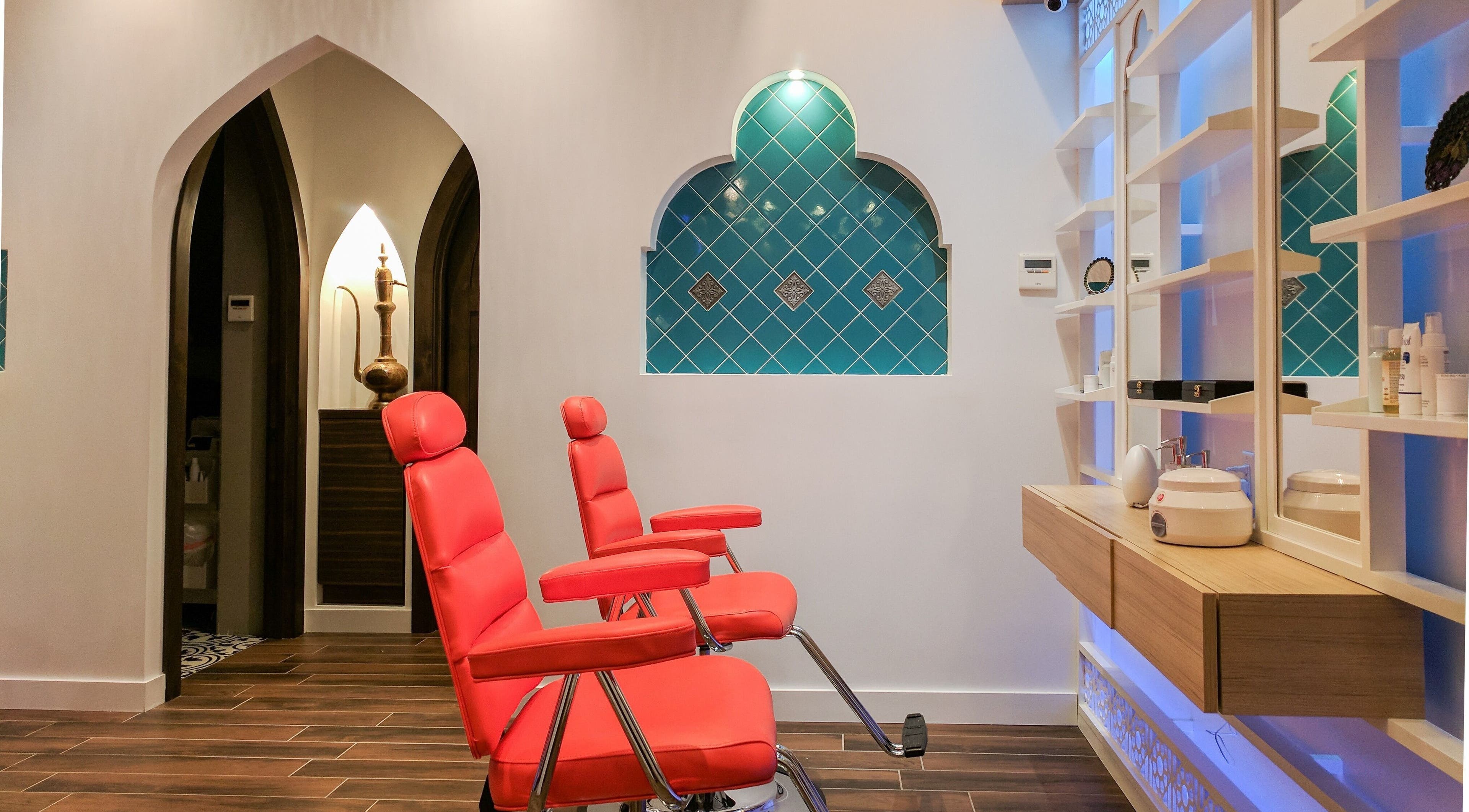 Interior of Blink Brow Bar Bute St, red chairs, elegant design in Vancouver, British Columbia, CA.