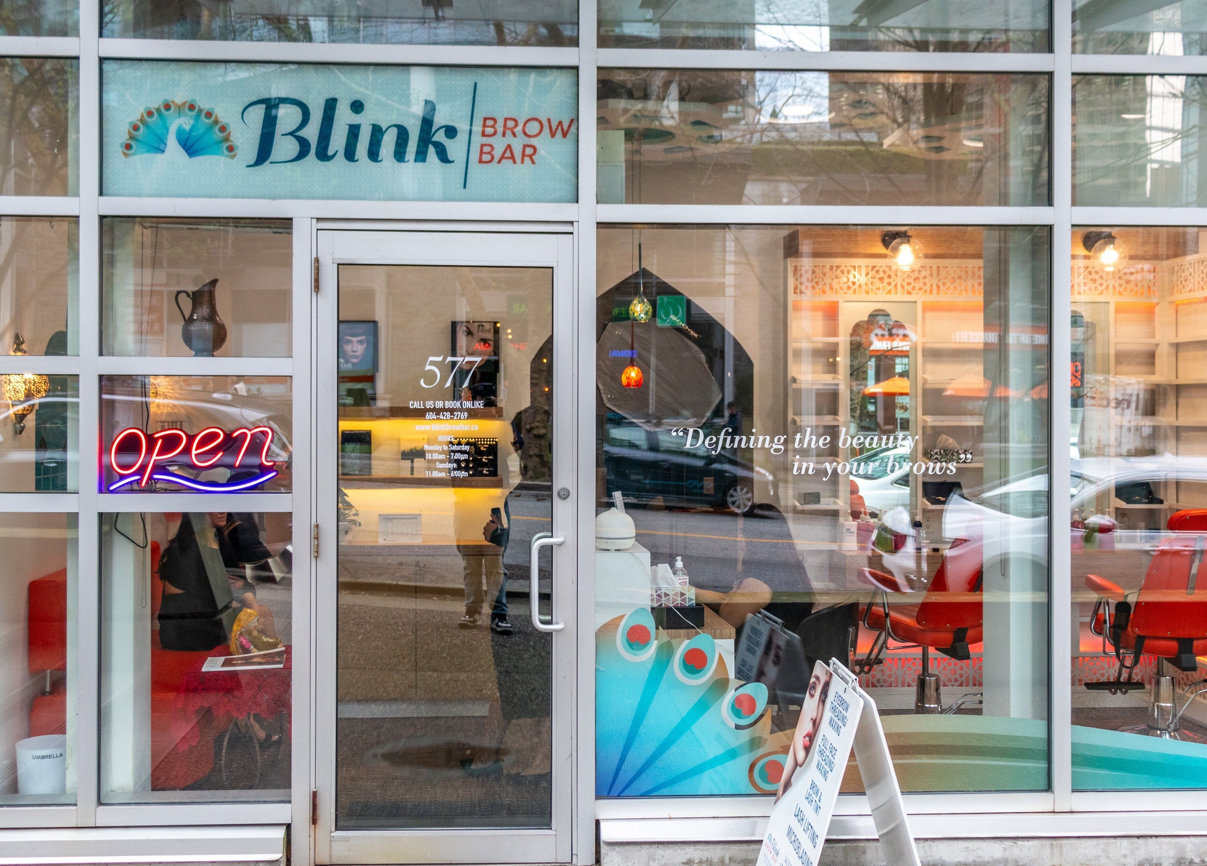 Front view of Blink Brow Bar Bute St in Vancouver, BC, showcasing signage and welcoming neon decor.