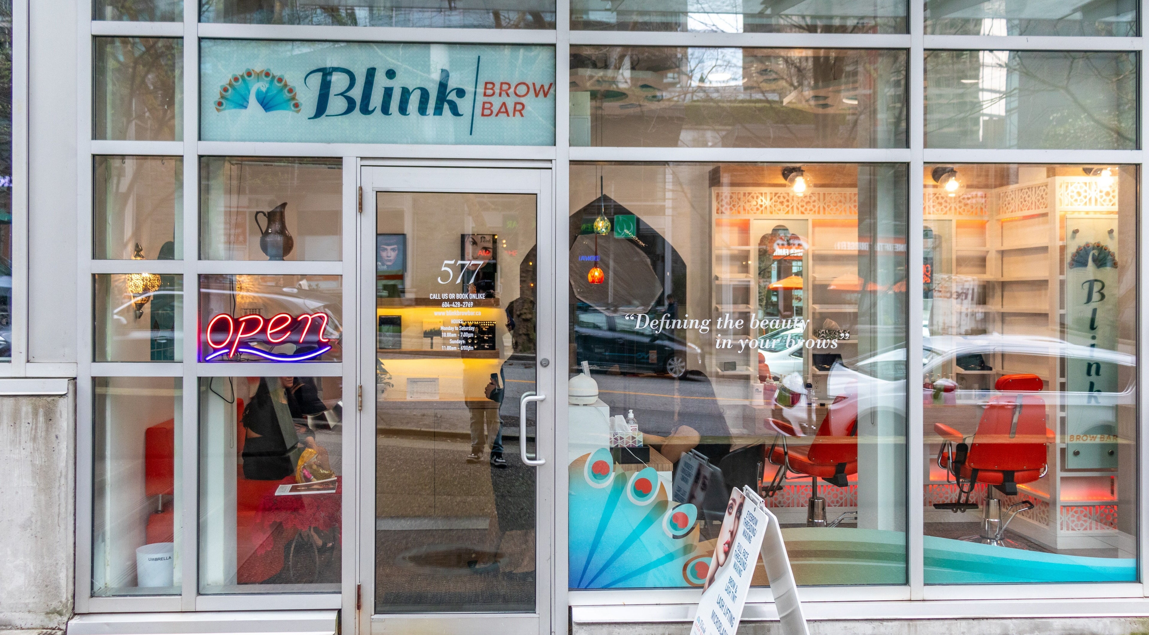 Front view of Blink Brow Bar Bute St in Vancouver, BC, showcasing signage and welcoming neon decor.