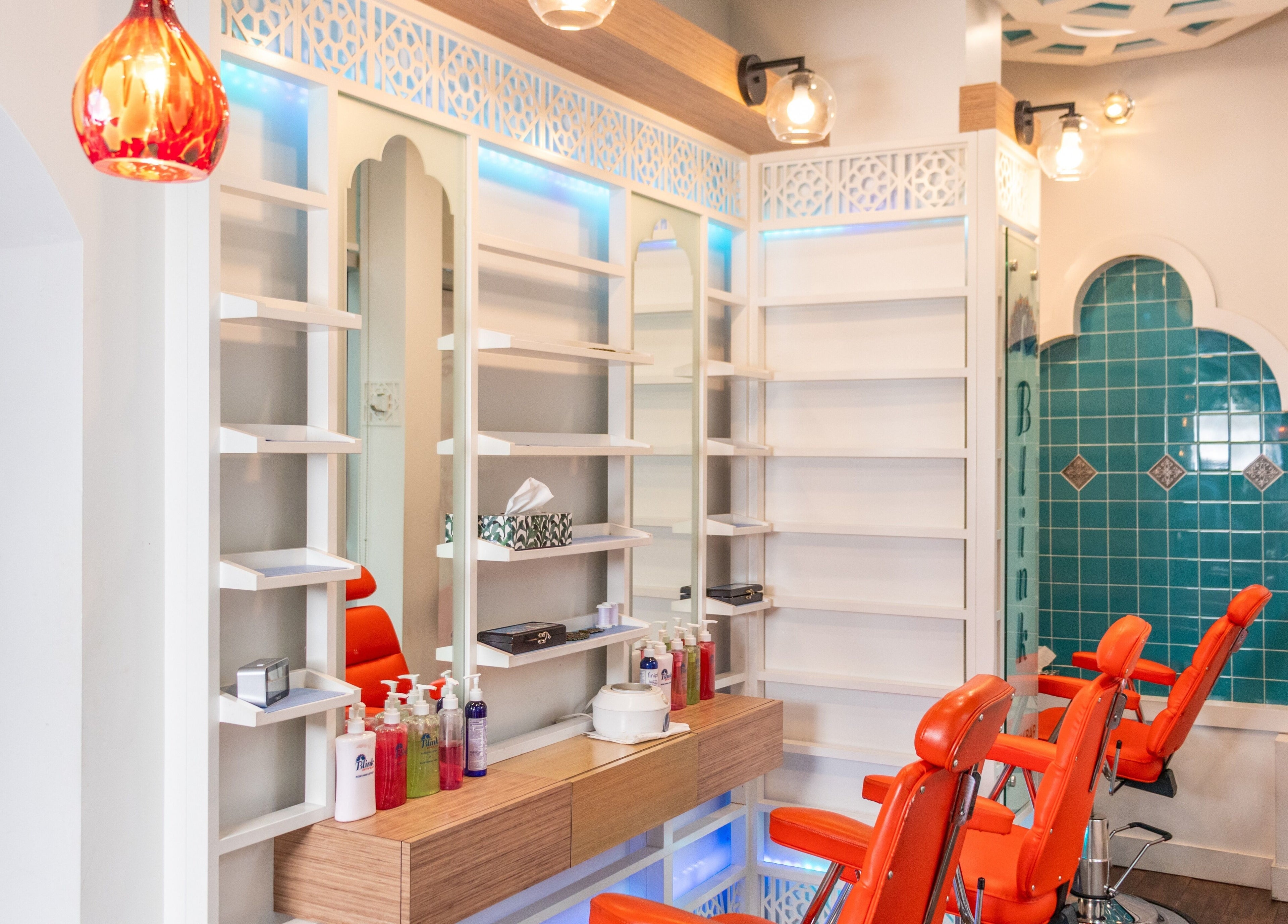 Interior of Blink Brow Bar Bute St in Vancouver, BC, CA featuring vibrant chairs and stylish decor.