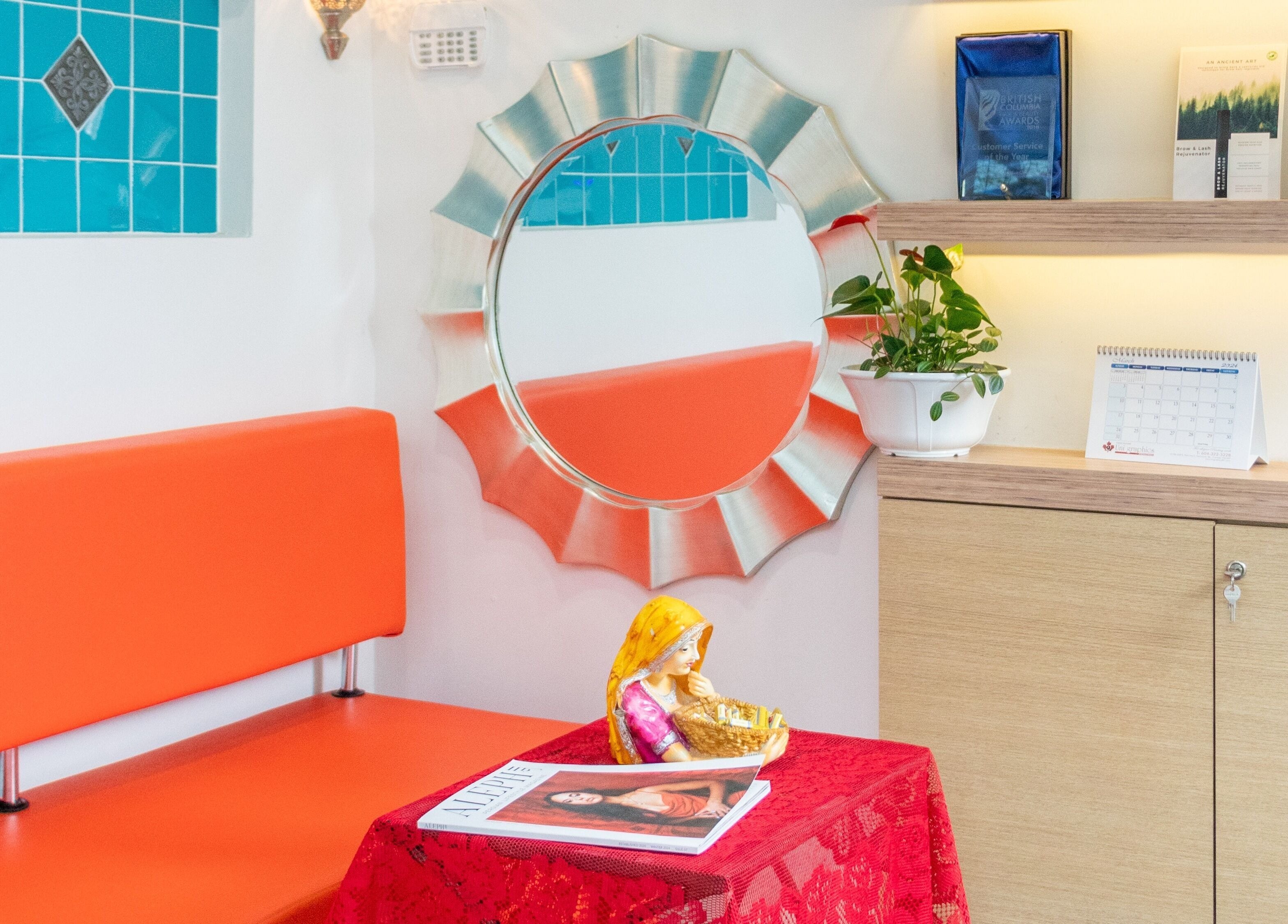 Cozy seating at Blink Brow Bar Bute St, Vancouver, British Columbia, CA with vibrant decor and lush greenery.