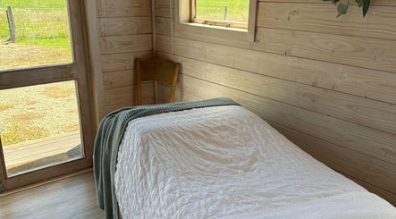 Tranquil room at Sarah Black, Culverden, Canterbury, NZ with cozy bed and natural wooden decor.