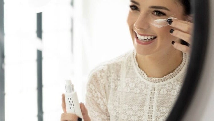 Woman applying cream at Skinvestment, Pretoria, Gauteng, ZA, highlighting beauty and wellness.