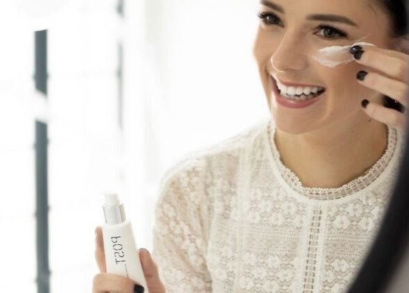 Woman applying cream at Skinvestment, Pretoria, Gauteng, ZA, highlighting beauty and wellness.