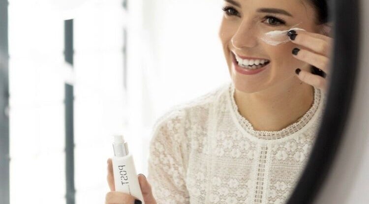 Woman applying cream at Skinvestment, Pretoria, Gauteng, ZA, highlighting beauty and wellness.