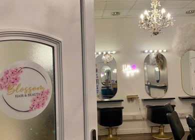 Elegant Dumbarton salon interior with chic mirrors and chandelier in Dumbarton, Scotland, GB.