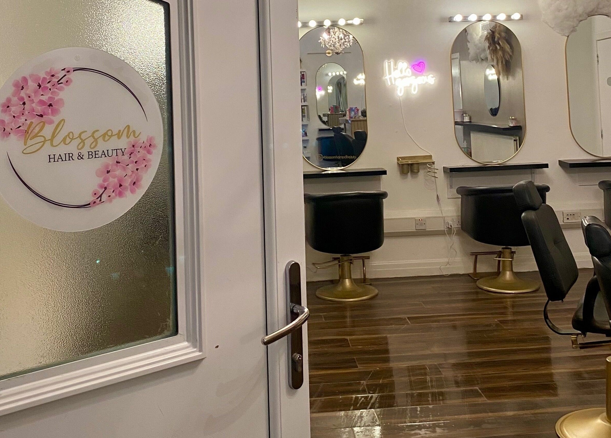 Entrance to Blossom Hair & Beauty in Dumbarton, Scotland featuring stylish mirrors and chairs.