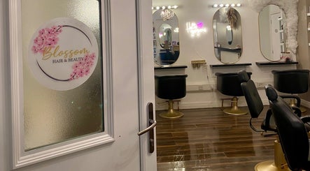 Entrance to Blossom Hair & Beauty in Dumbarton, Scotland featuring stylish mirrors and chairs.