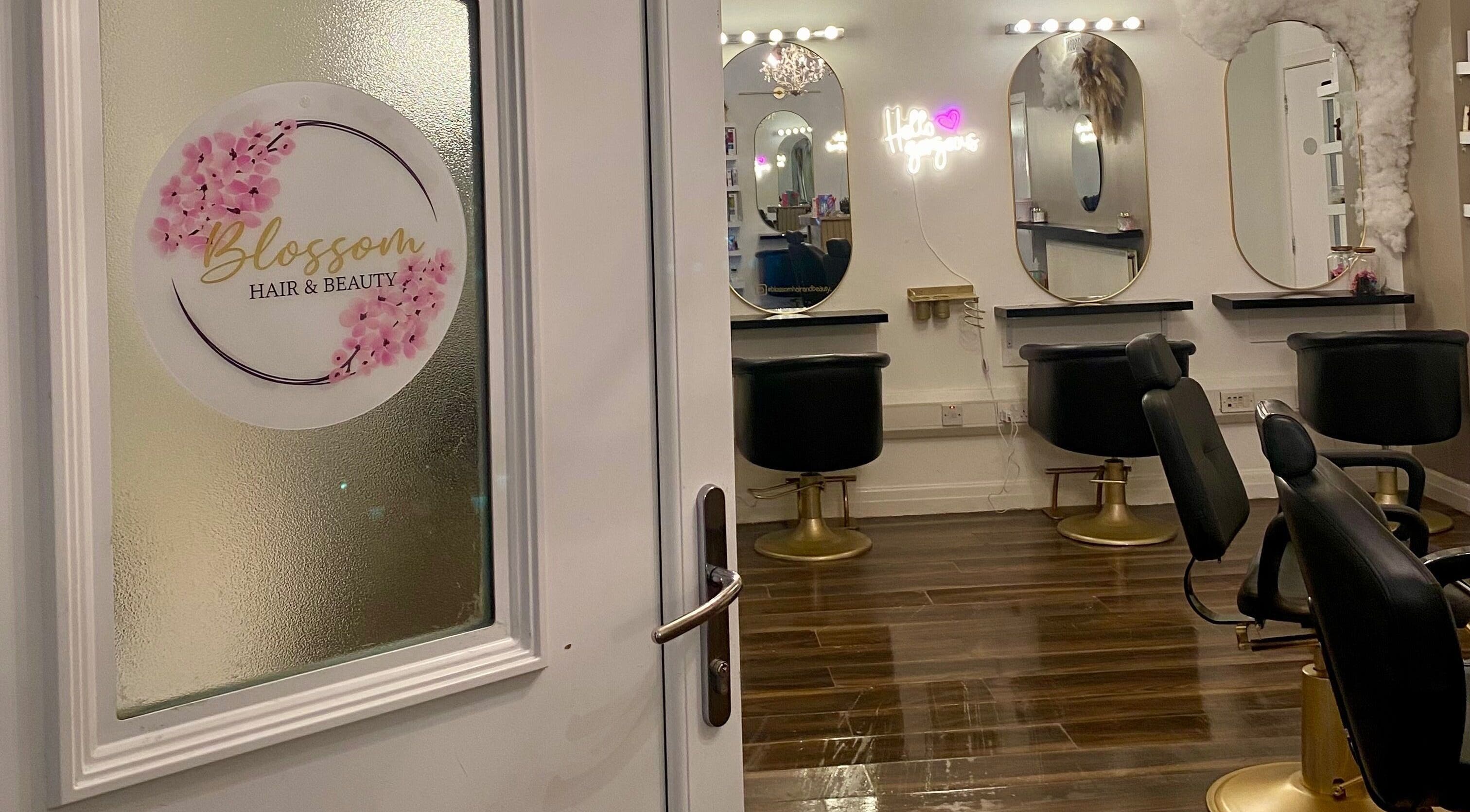 Entrance to Blossom Hair & Beauty in Dumbarton, Scotland featuring stylish mirrors and chairs.