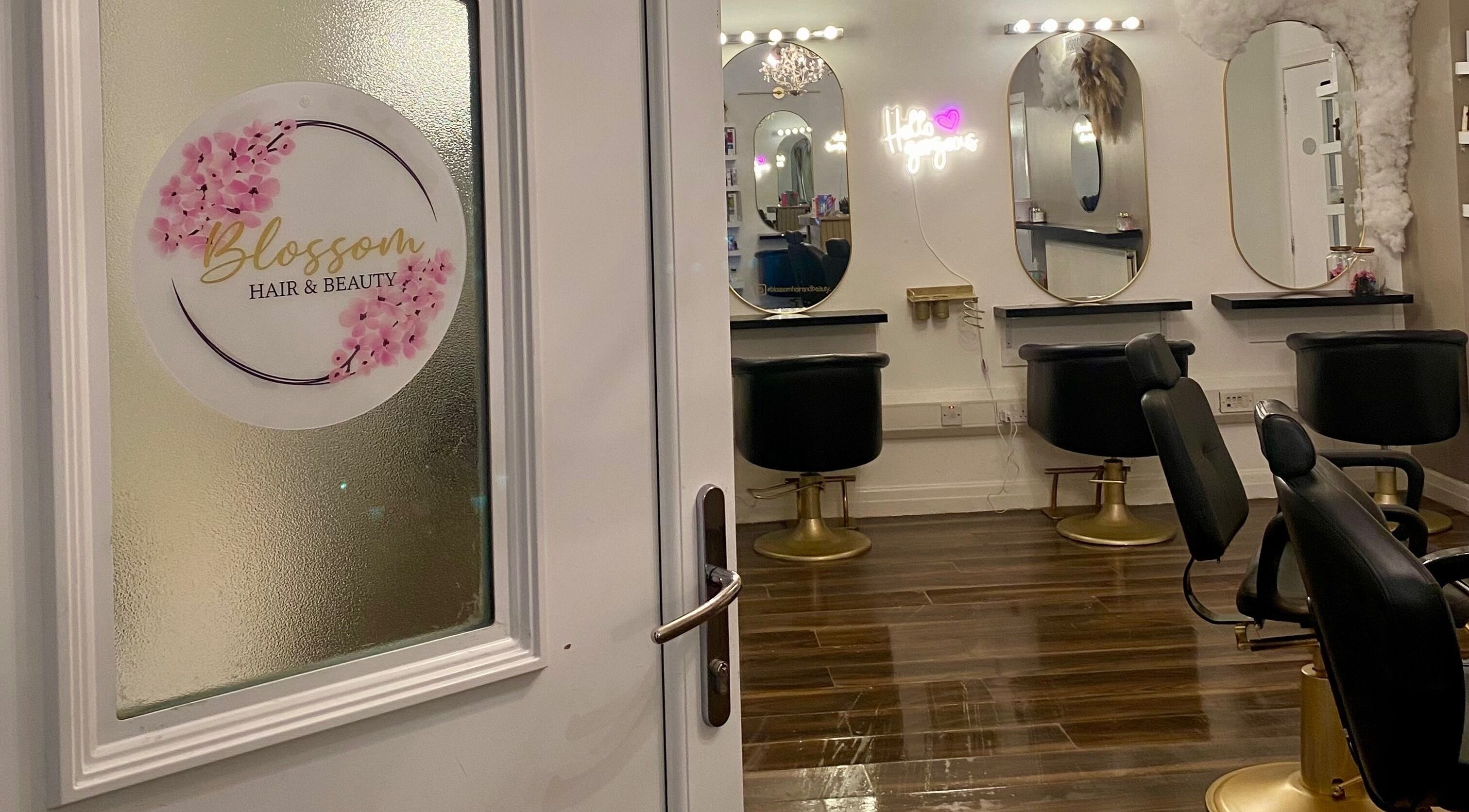 Entrance to Blossom Hair & Beauty in Dumbarton, Scotland featuring stylish mirrors and chairs.