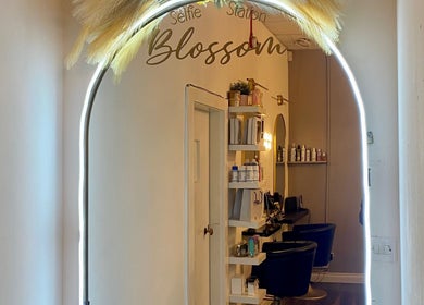 Selfie station at Blossom Hair & Beauty, Dumbarton, Scotland, GB, showcasing modern interior and styling chairs.