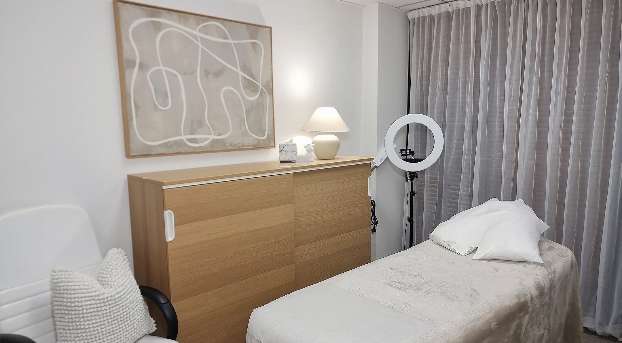 Relaxing treatment room at Delta Beauty Salon, Phillip, ACT with a cozy bed and soft lighting.