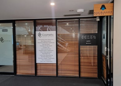 Entrance of Delta Beauty Salon in Phillip, Australian Capital Territory, AU, featuring modern glass doors.
