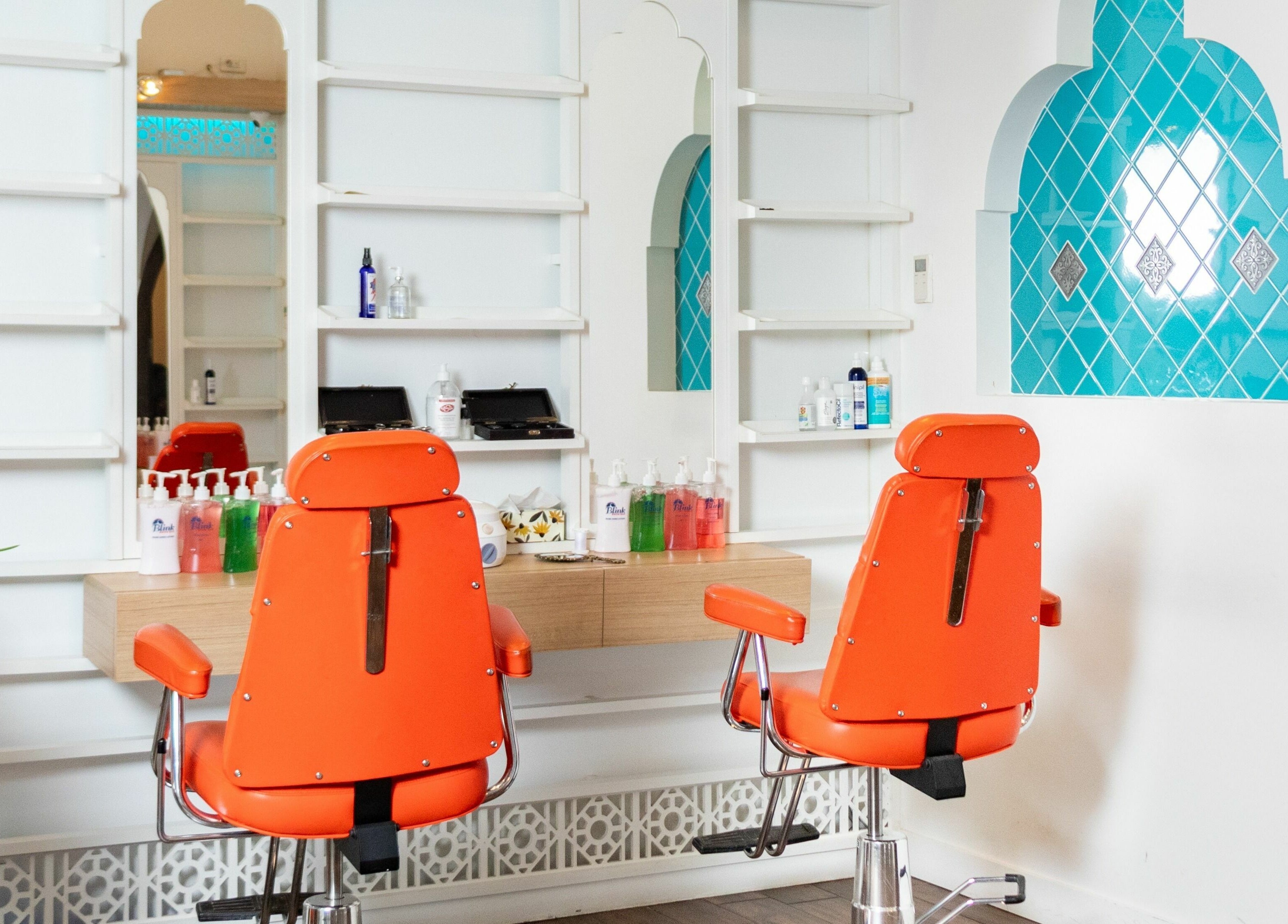 Bright orange chairs in modern interior of Blink Brow Bar, Vancouver, British Columbia, CA.