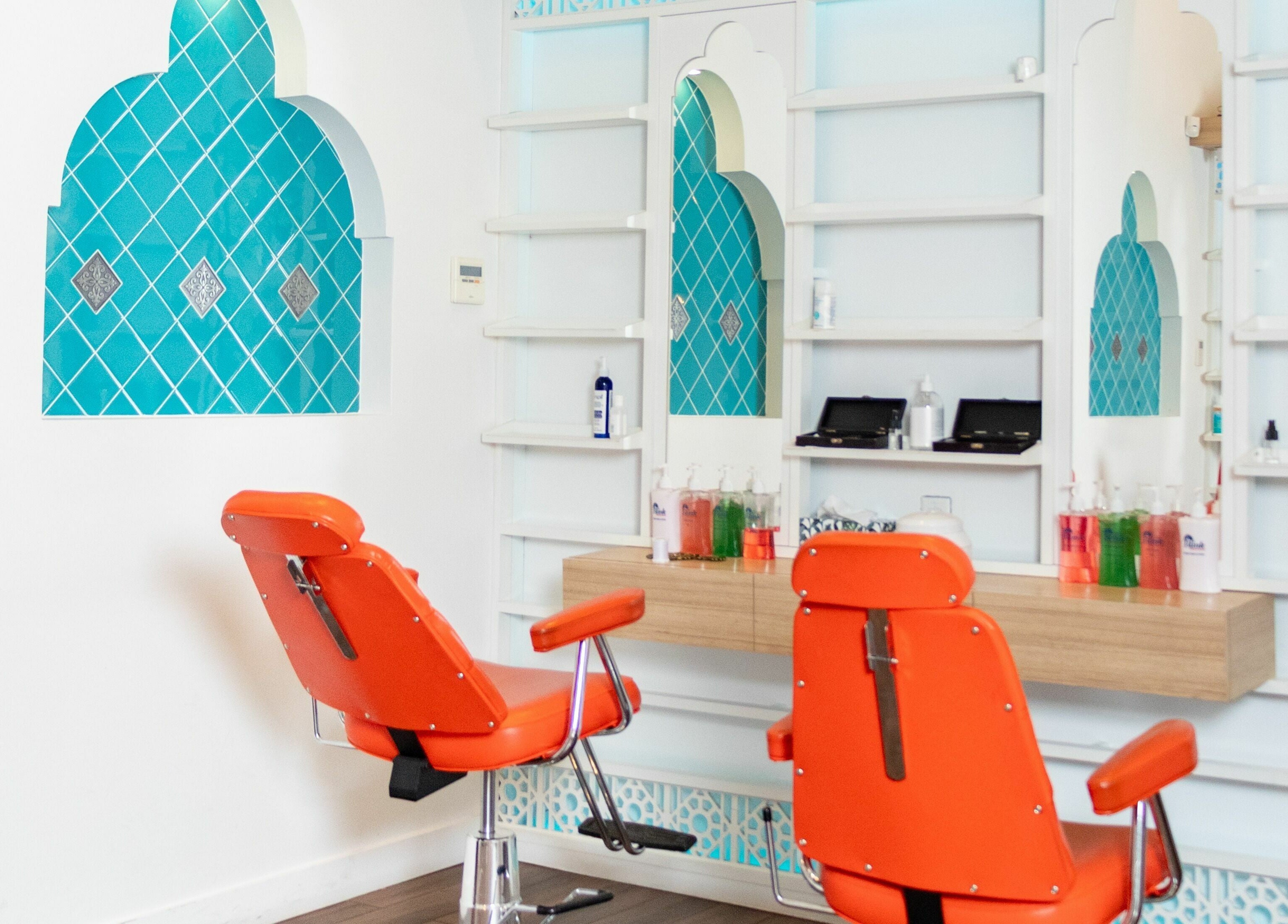 Modern salon chairs at Blink Brow Bar, Vancouver, British Columbia, CA with chic turquoise decor.