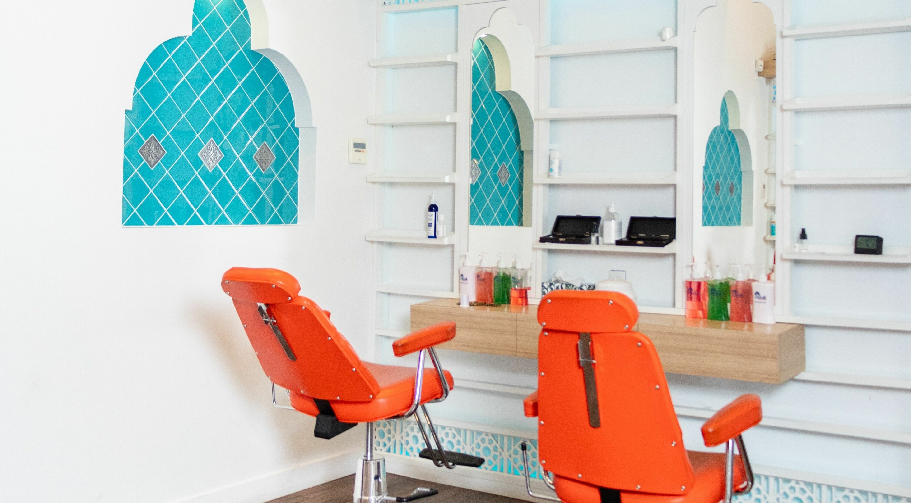 Modern salon chairs at Blink Brow Bar, Vancouver, British Columbia, CA with chic turquoise decor.
