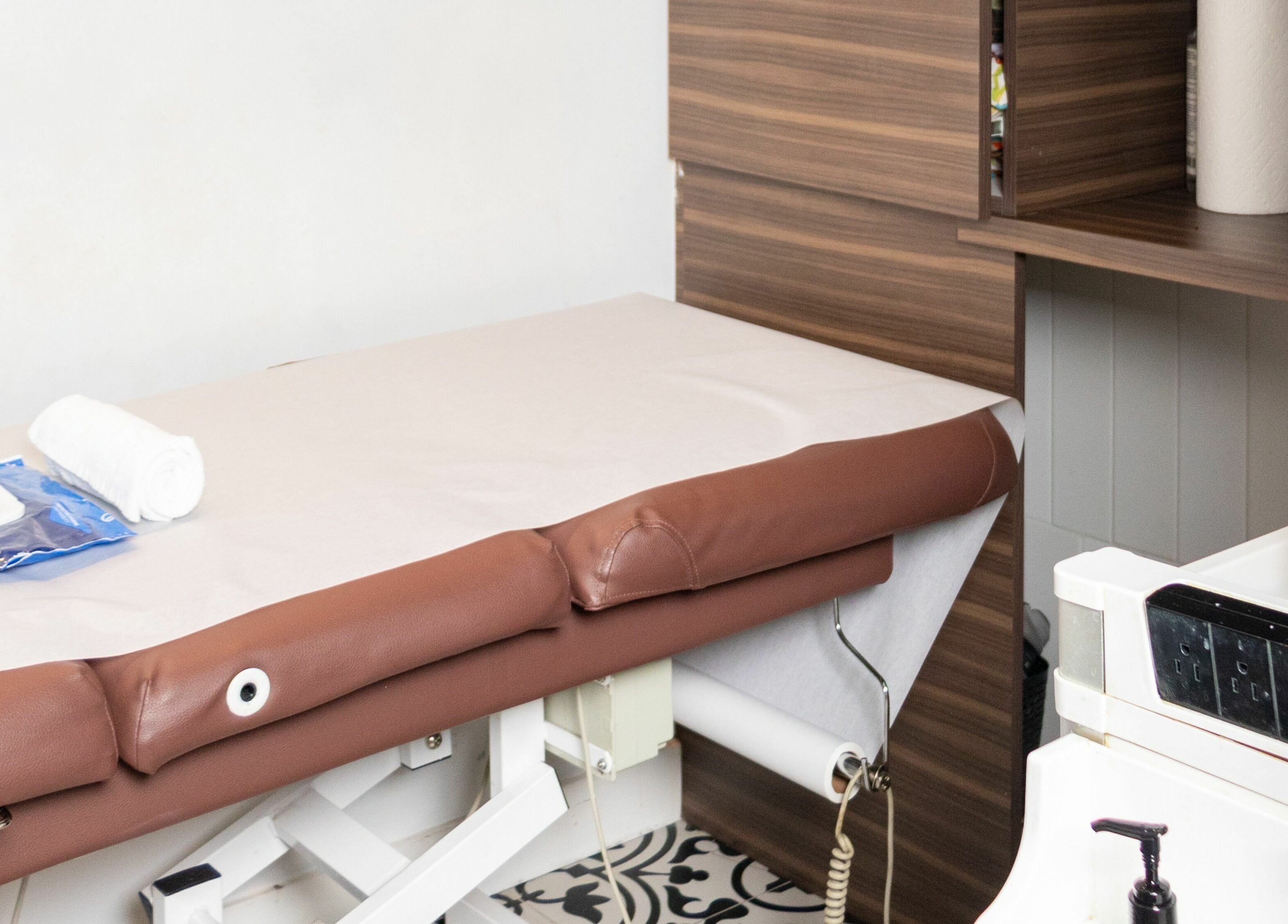 Cozy spa treatment room at Blink Brow Bar, Vancouver, British Columbia, CA, featuring a brown massage table.