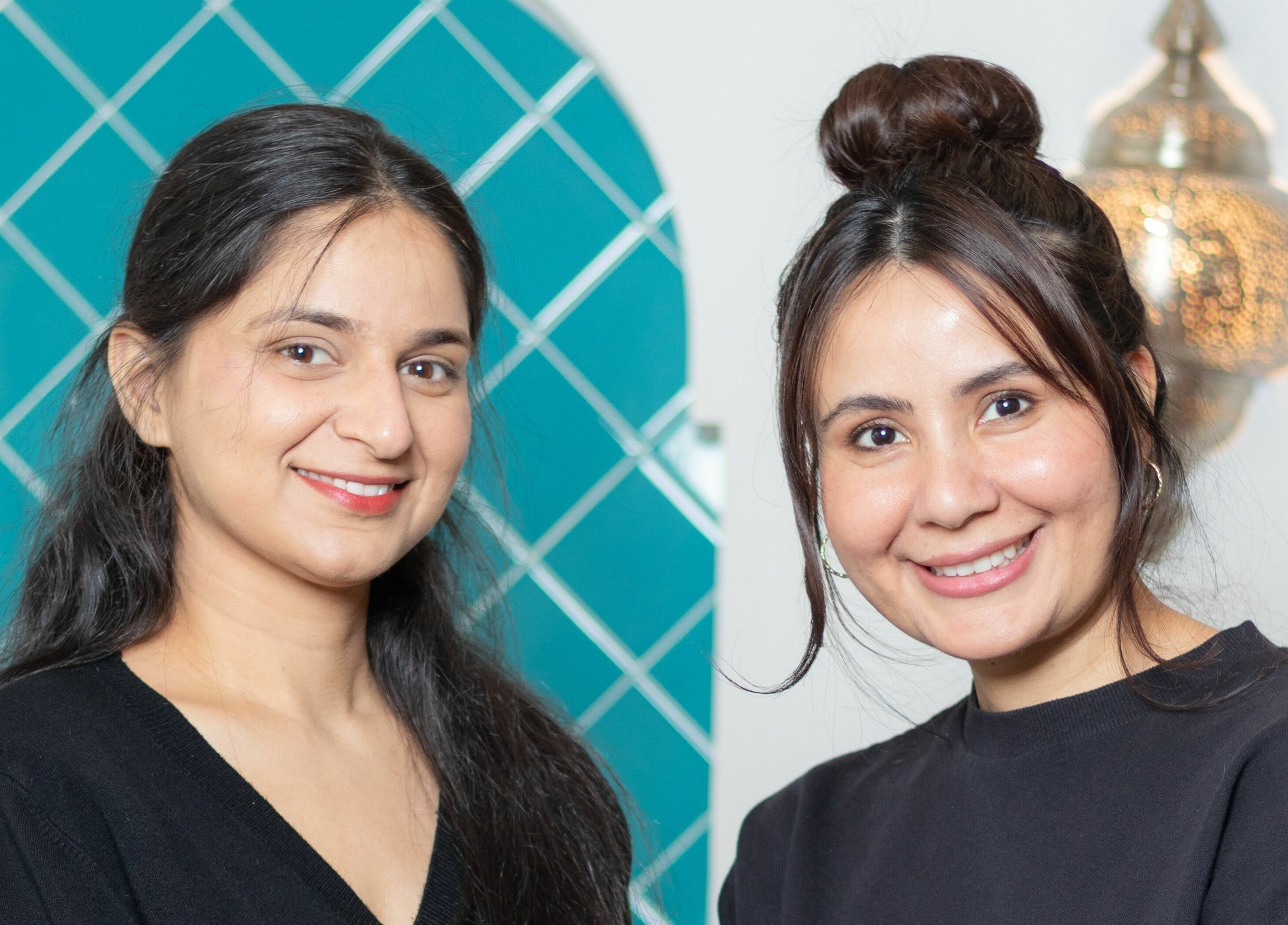 Team members smiling at Blink Brow Bar in Vancouver, British Columbia, CA, showcasing professional service.