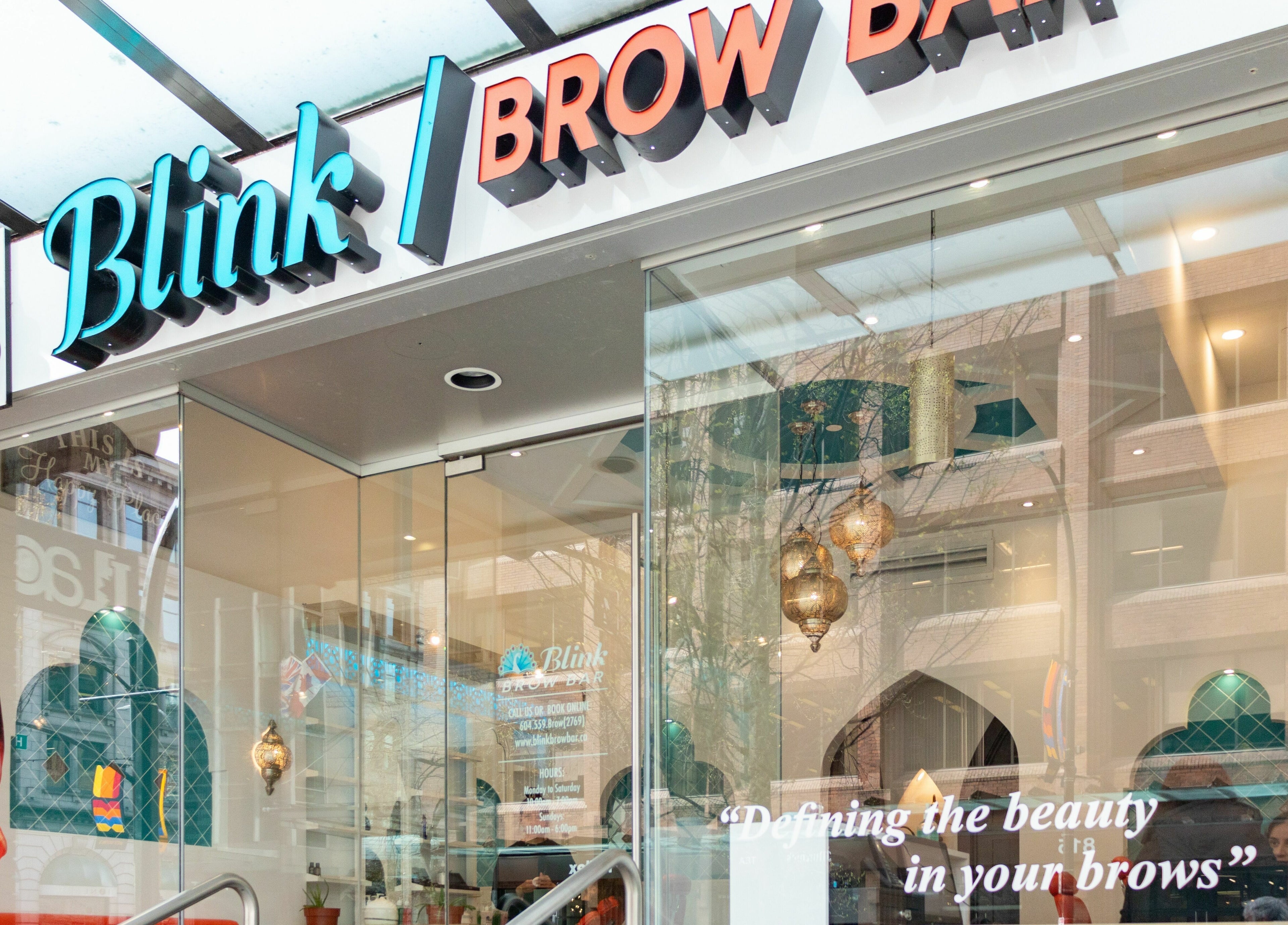 Front view of Blink Brow Bar in Vancouver, British Columbia, CA, showcasing modern glass facade and elegant decor.
