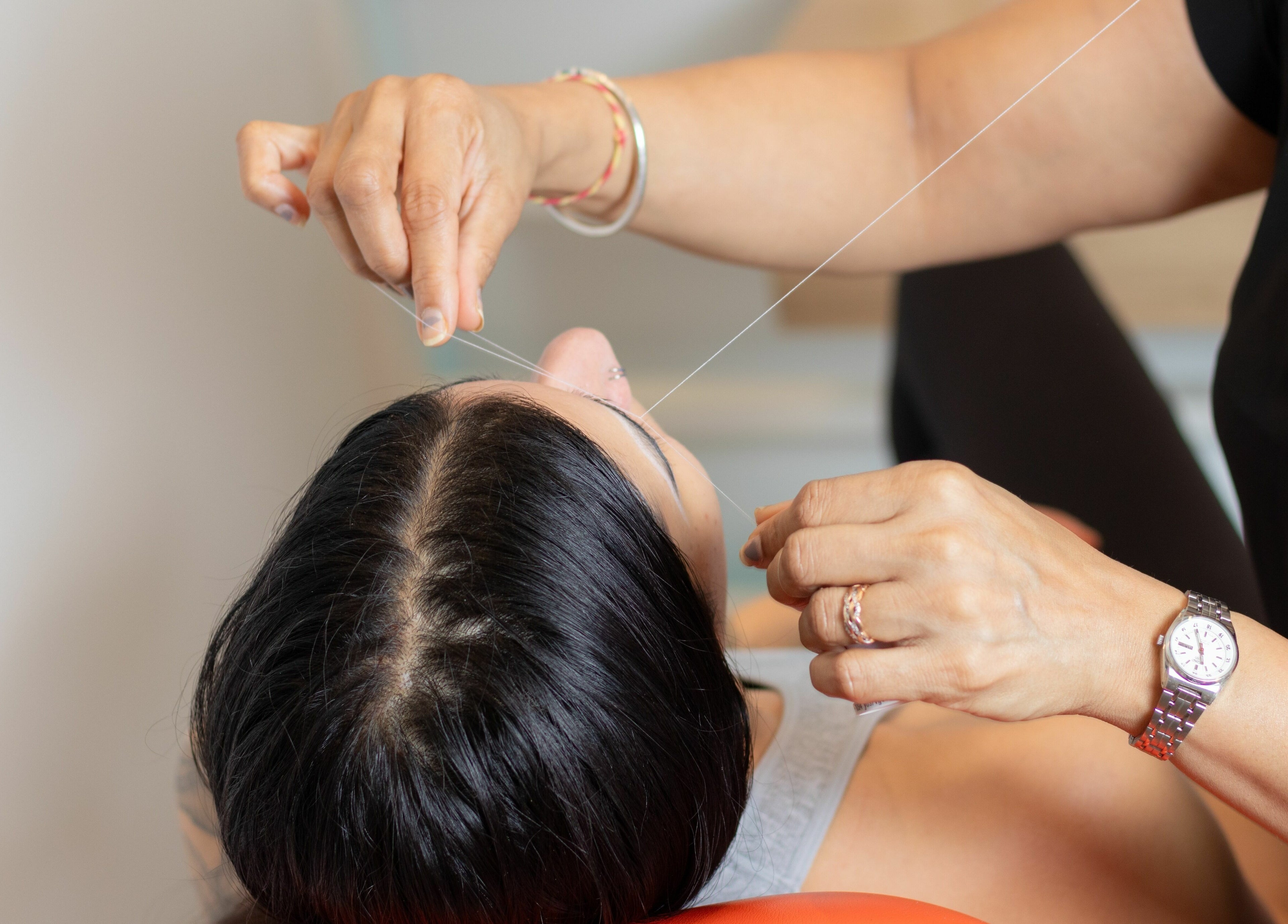 Professional threading service at Blink Brow Bar, Vancouver, British Columbia, CA, enhancing facial features.