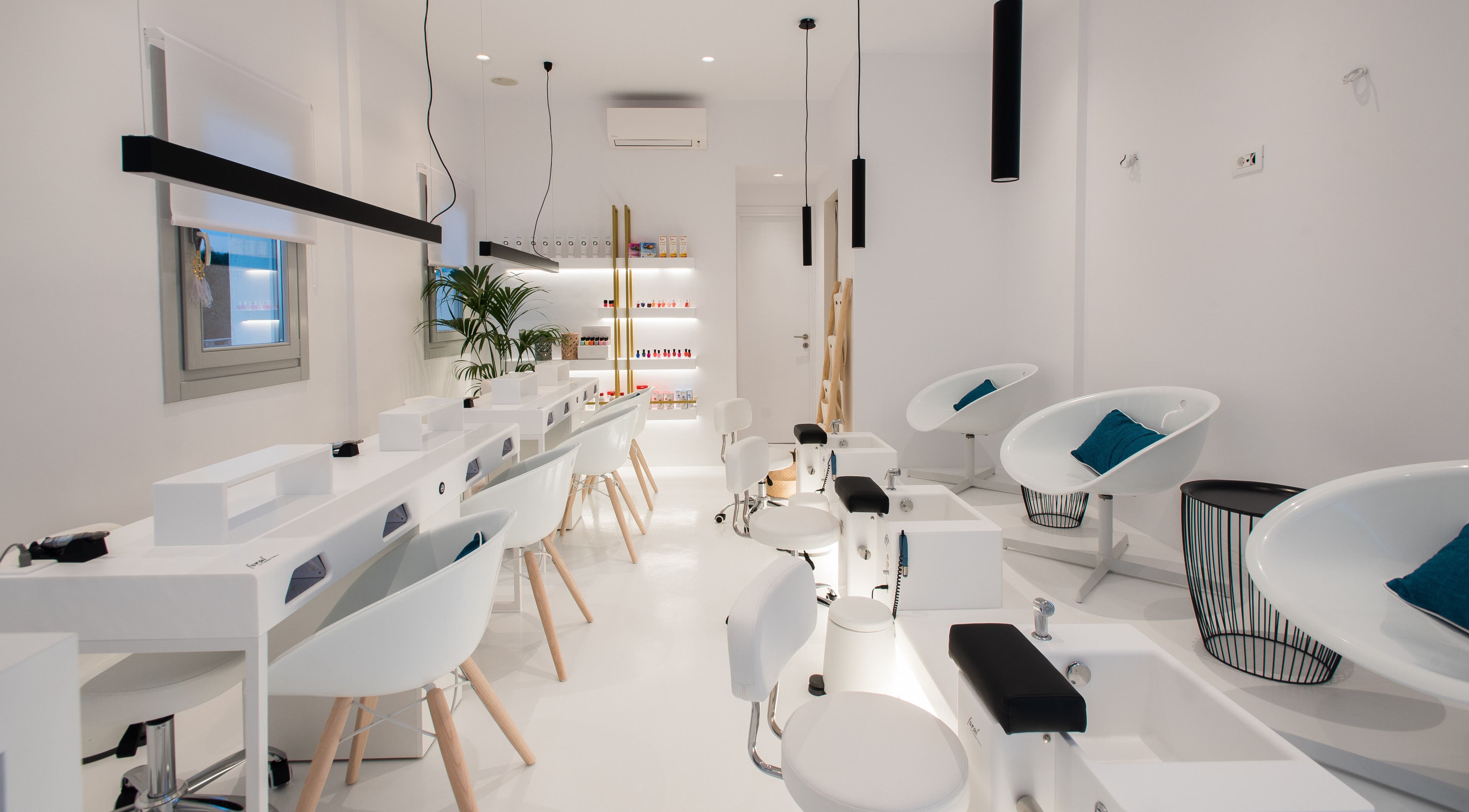 Modern interior of Turquoise Luxury Nails Care in ΜΥΚΟΝΟΣ, GR, featuring chic white and teal decor.