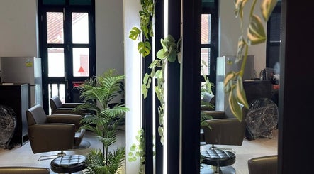 Chic interior of RASL: Refined Artisan Salon Lounge, Singapore, SG, with modern chairs and lush plants.