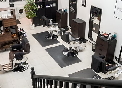 Modern interior of RABL: Refined Artisan Barber Lounge, Singapore, featuring stylish chairs and sleek decor.