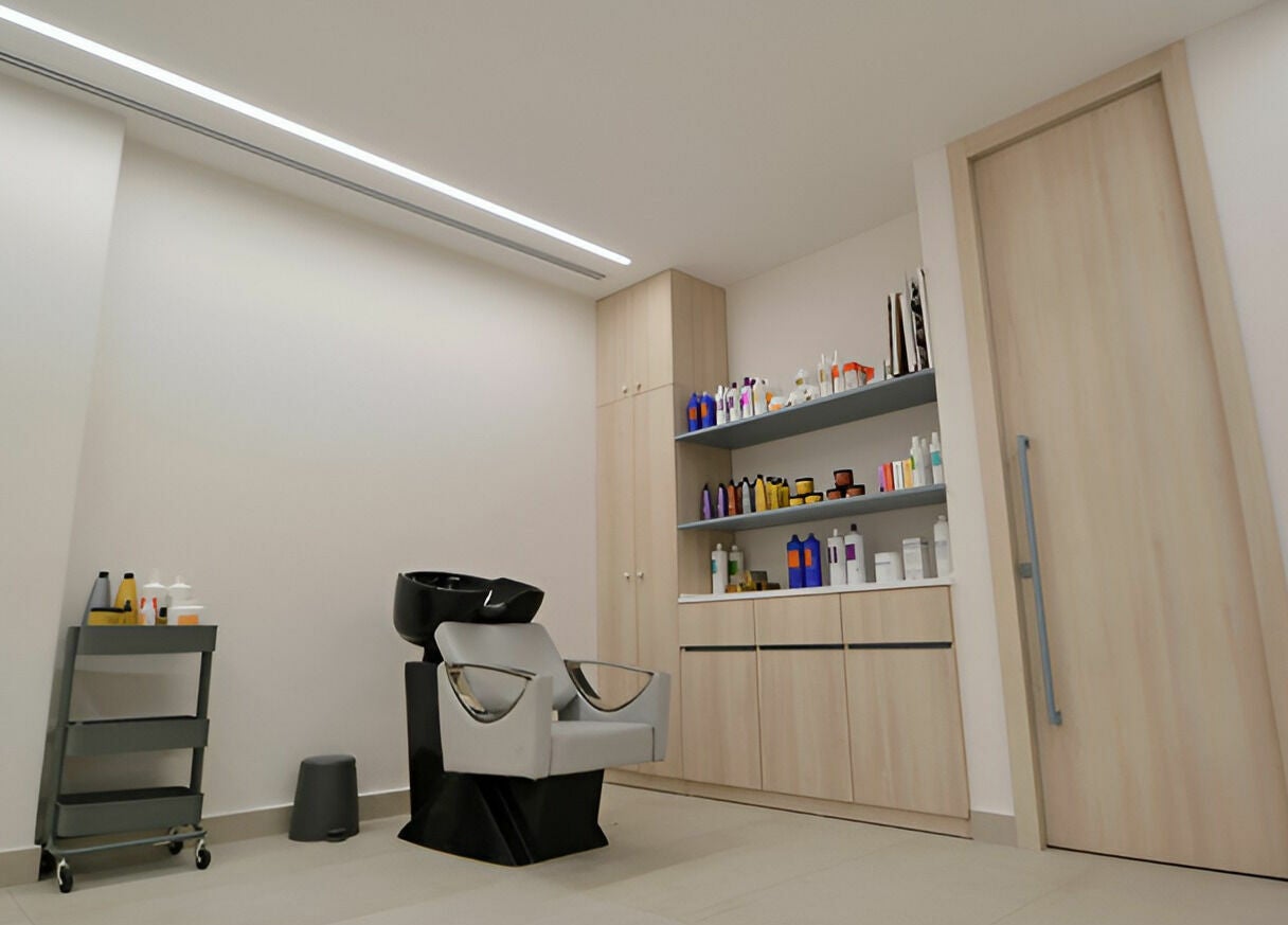 Chic salon interior at Calamantina Rabia, Amman, Amman Governorate, JO with wash station and product shelves.