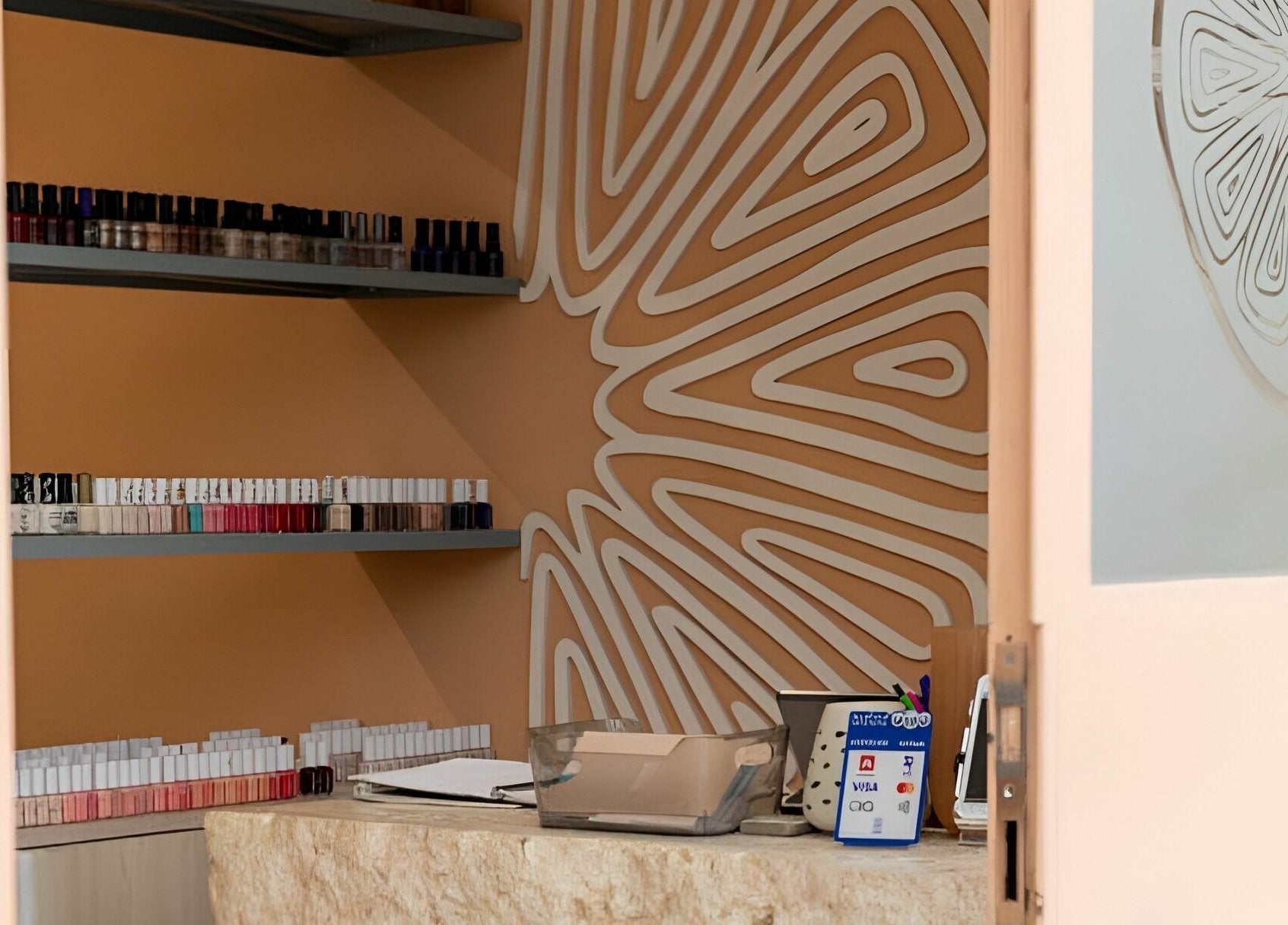 Manicure station at Calamantina Rabia, Amman, Amman Governorate, JO featuring stylish nail polishes.
