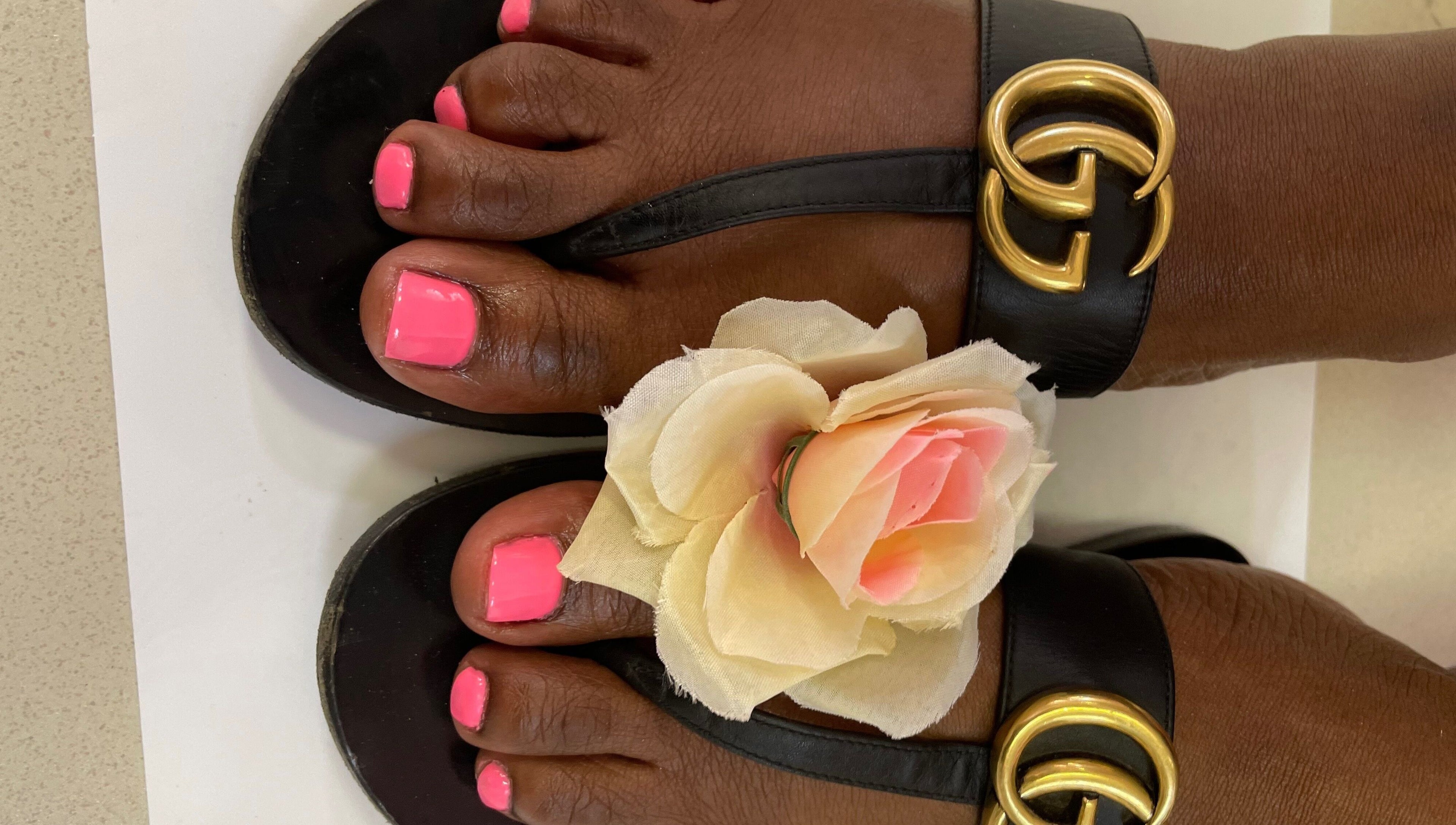Elegant pink pedicure with floral accent at Brushed Nails by Nobi, Randburg, Gauteng, ZA.