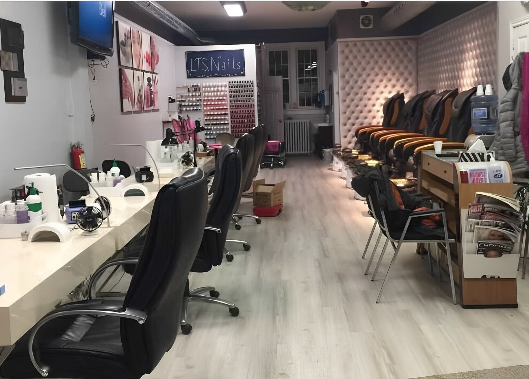 Elegant salon setup at LTS Nails, Toronto, Ontario, CA showcasing manicure stations and cozy seating.