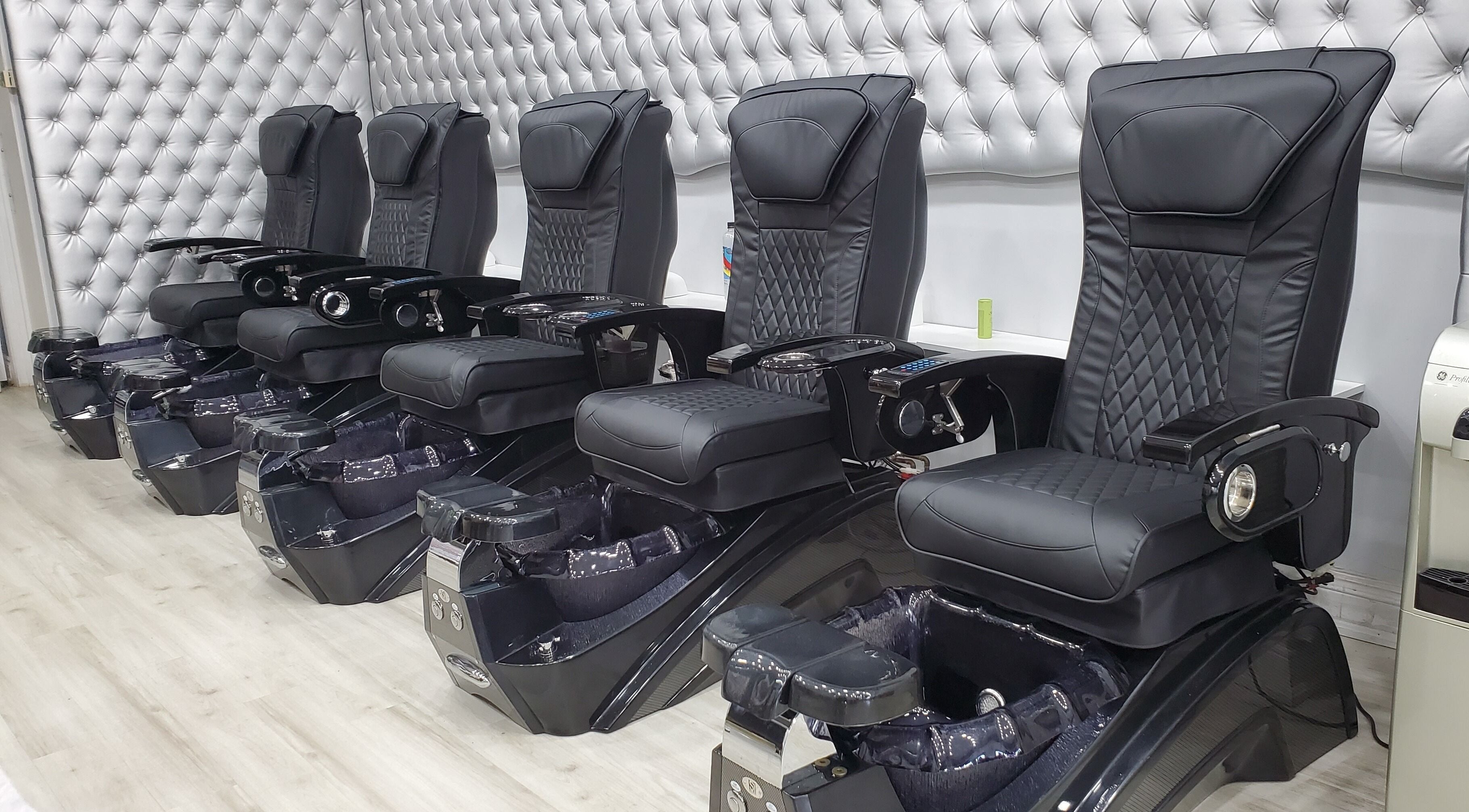 Luxurious black pedicure chairs at LTS Nails, Toronto, Ontario, CA for premium nail care.