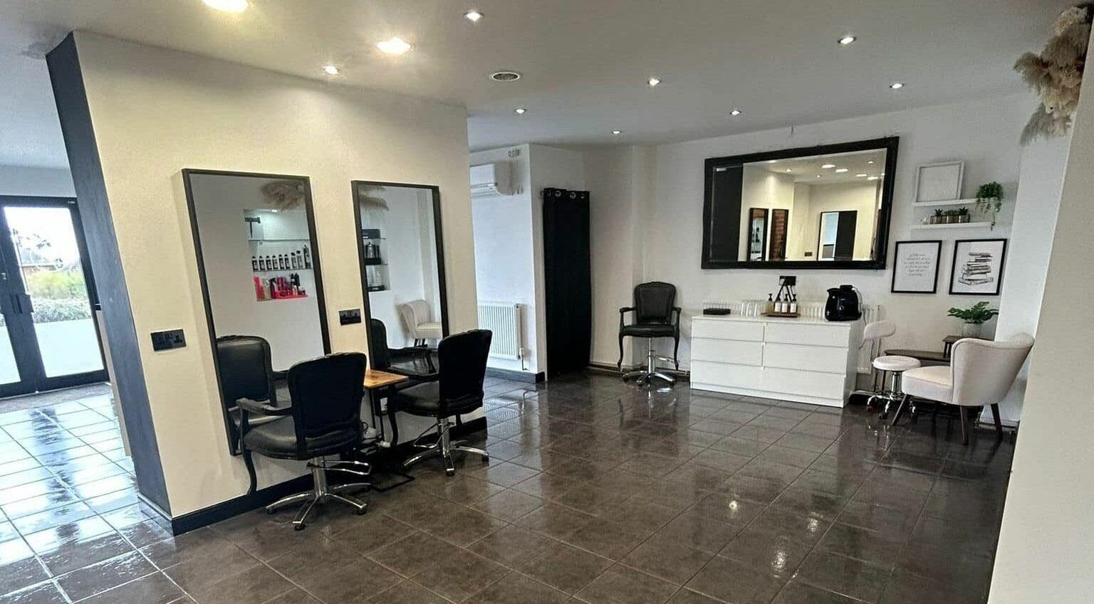 Modern salon interior at Lm Hair And Beauty Lounge, Sheffield, England, GB with chic decor and styling stations.