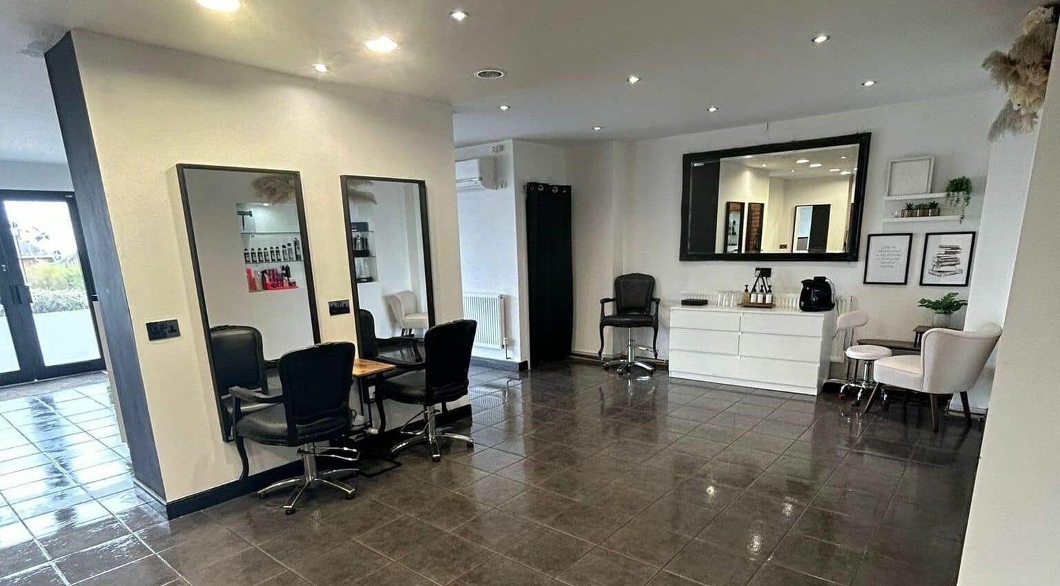 Modern salon interior at Lm Hair And Beauty Lounge, Sheffield, England, GB with chic decor and styling stations.