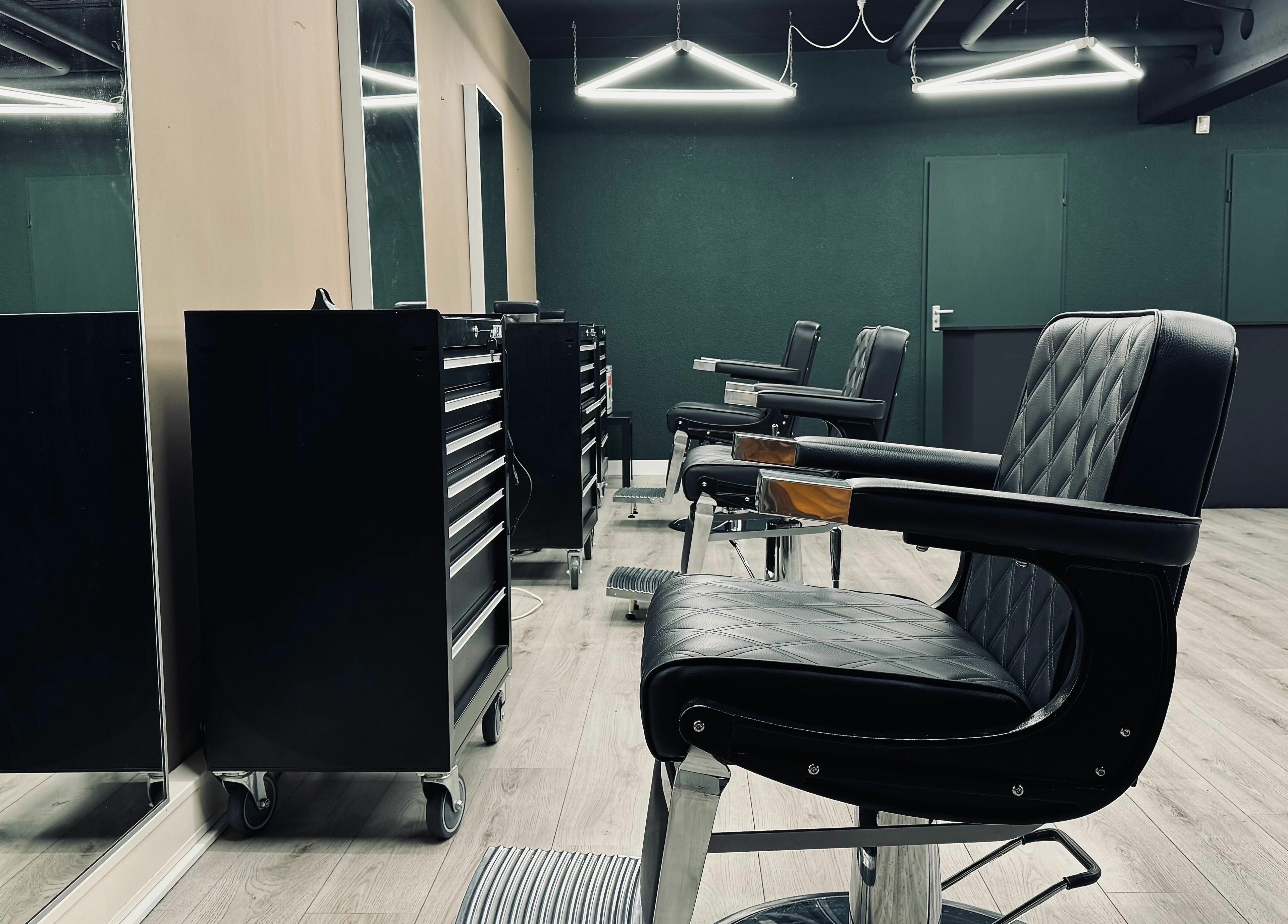 Modern barber chairs at Daily Grind Barbershop in Rotterdam, Zuid-Holland, NL showcasing sleek interior design.