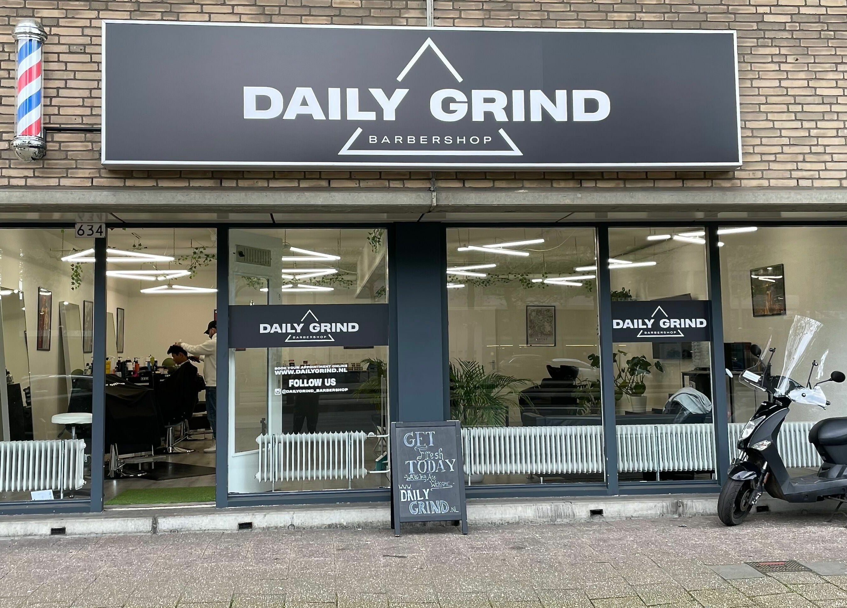 Exterior view of Daily Grind Barbershop in Rotterdam, Zuid-Holland, NL showcasing stylish design.