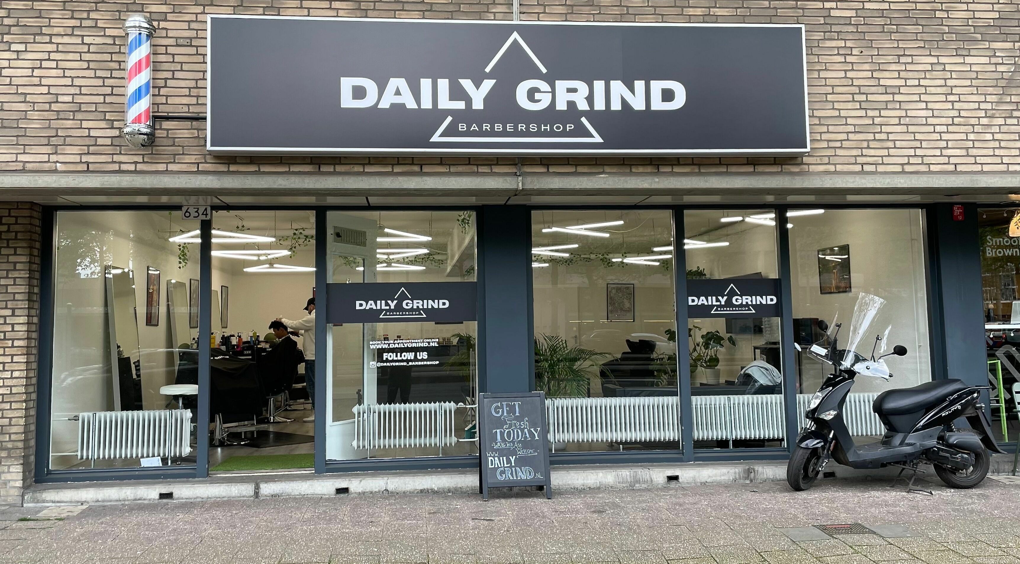 Exterior view of Daily Grind Barbershop in Rotterdam, Zuid-Holland, NL showcasing stylish design.