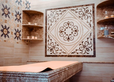 Luxurious treatment room at The Stars Barber in Dubai, AE with intricate tile design and ambient lighting.