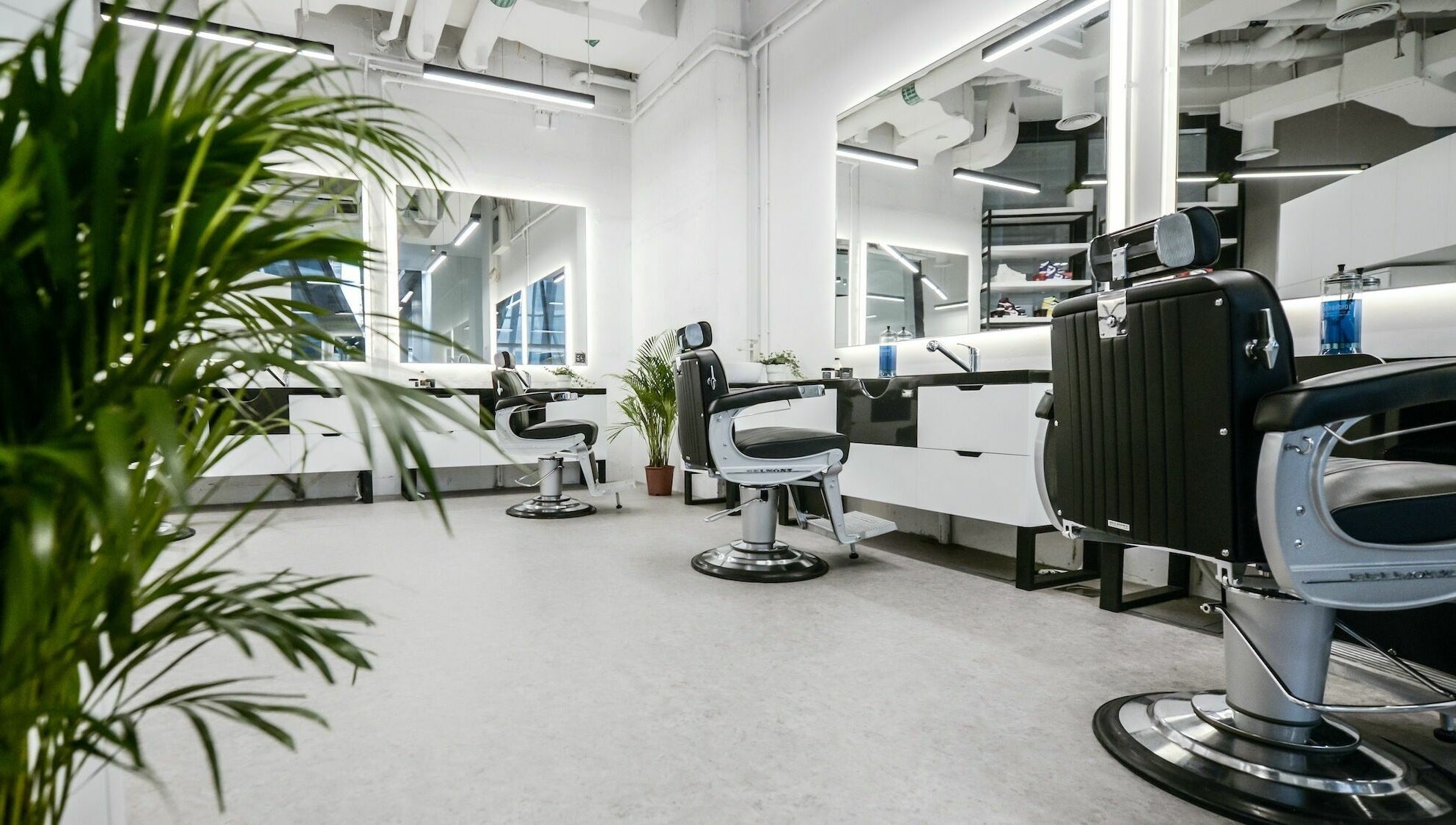 Modern barber chairs at YARD Barber and Shop in Dubai, AE, showcasing sleek design and comfort.