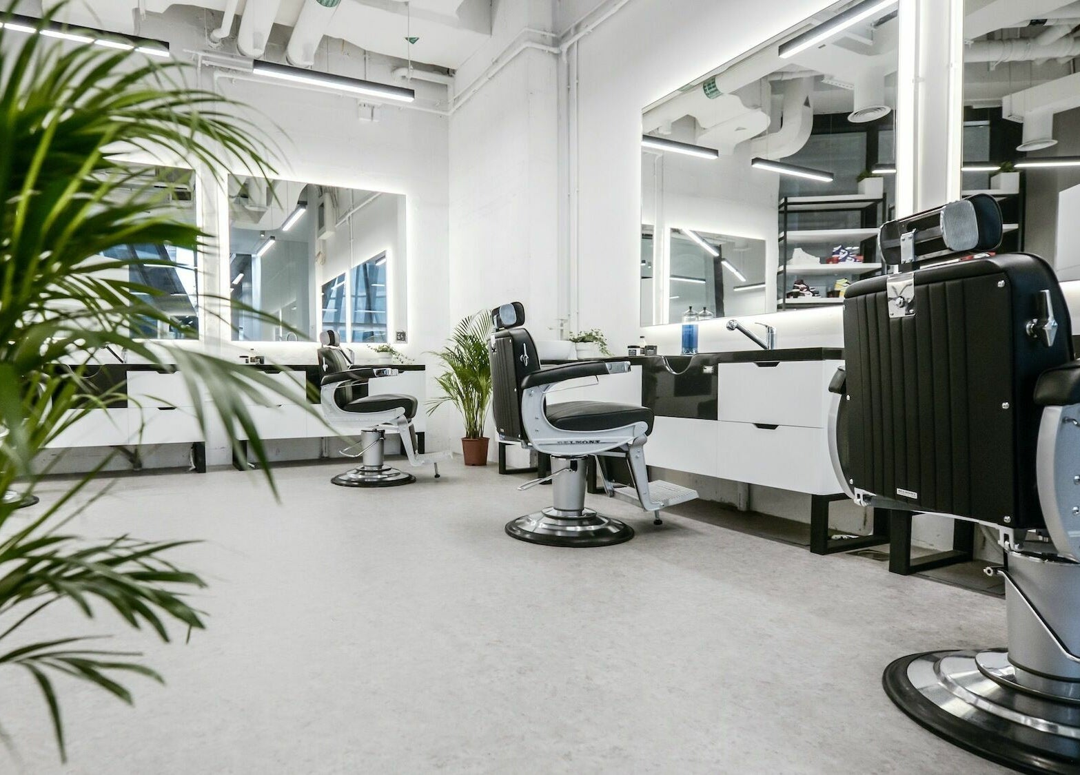 Modern barber chairs at YARD Barber and Shop in Dubai, AE, showcasing sleek design and comfort.